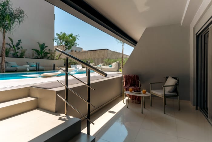 a patio with a pool and a chair
