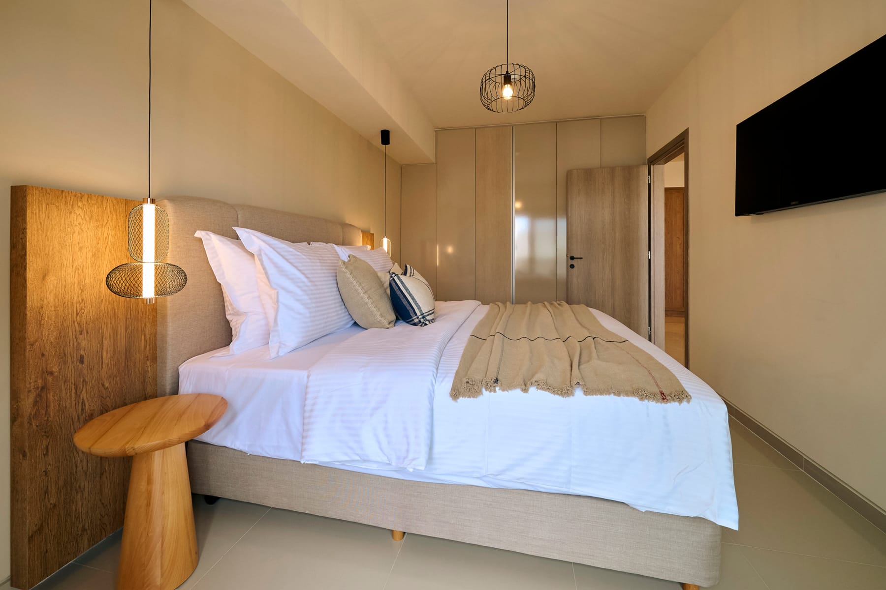a bed with pillows and a lamp