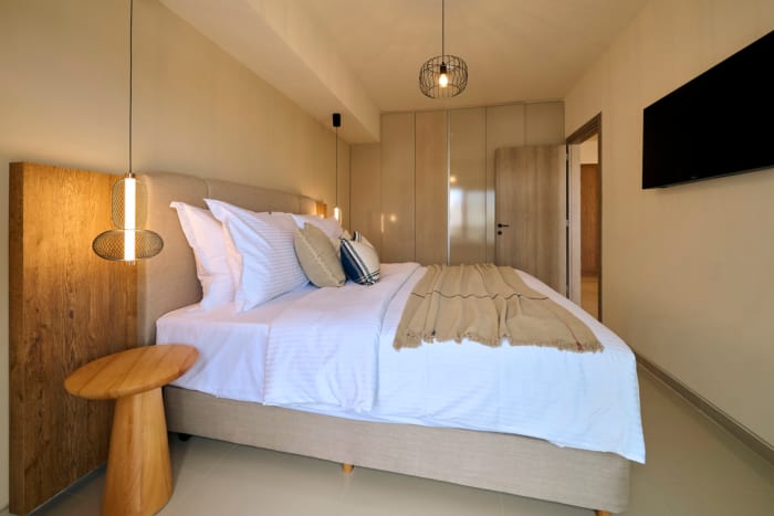 a bed with pillows and a lamp