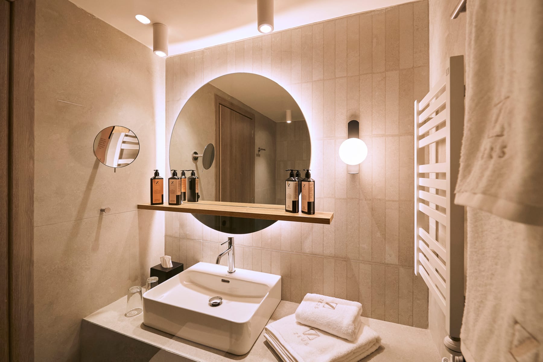 a bathroom with a round mirror