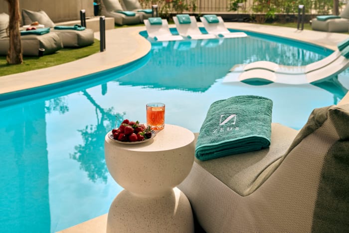 a pool with a drink and a towel