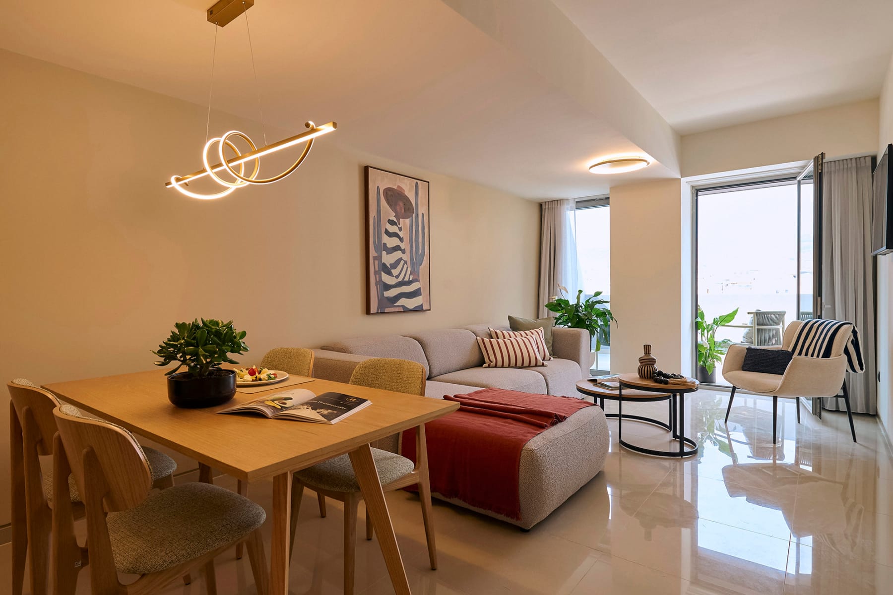 a living room with a table and chairs