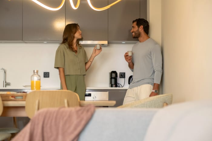 a person and person standing in a kitchen