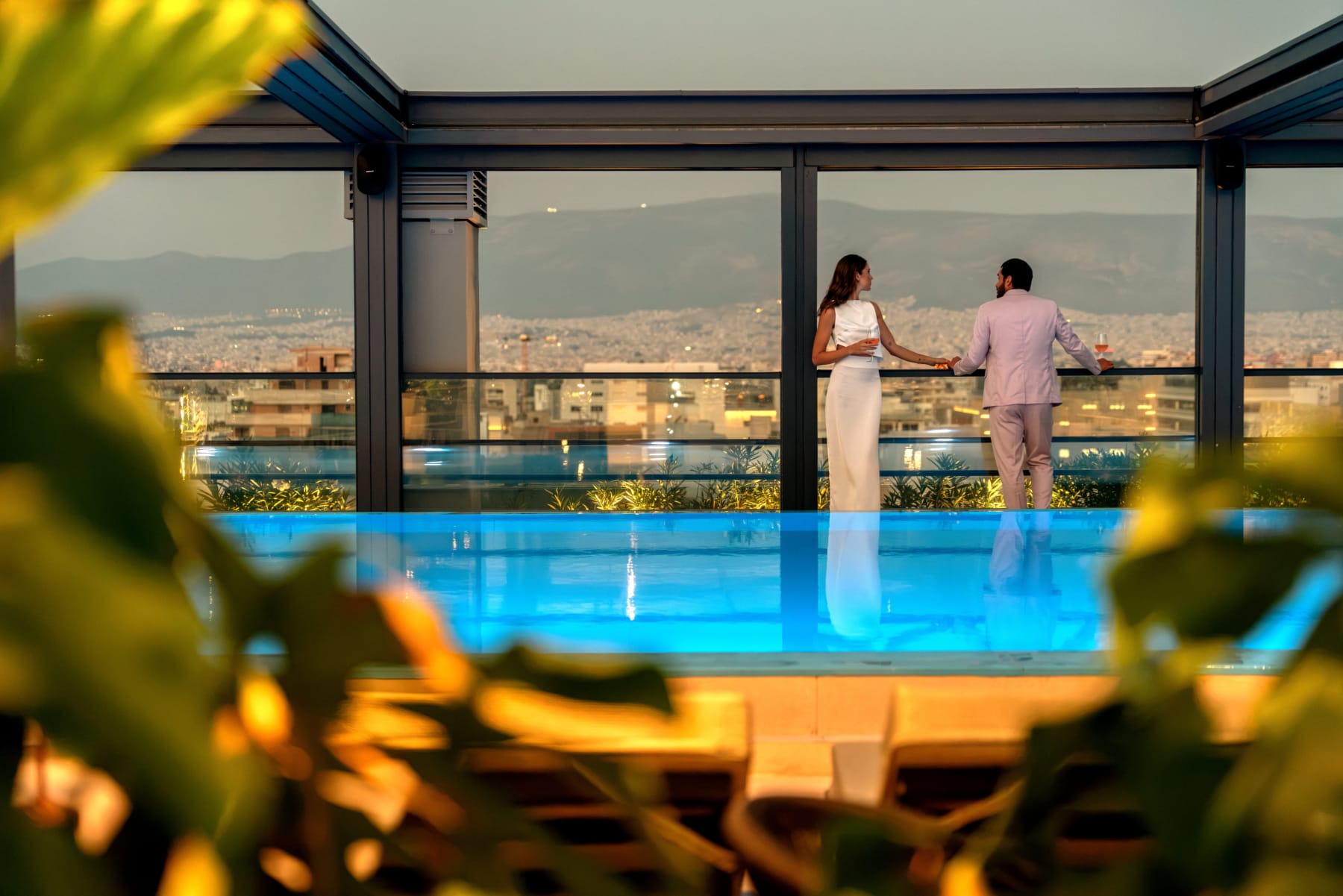 a person and person standing by a pool