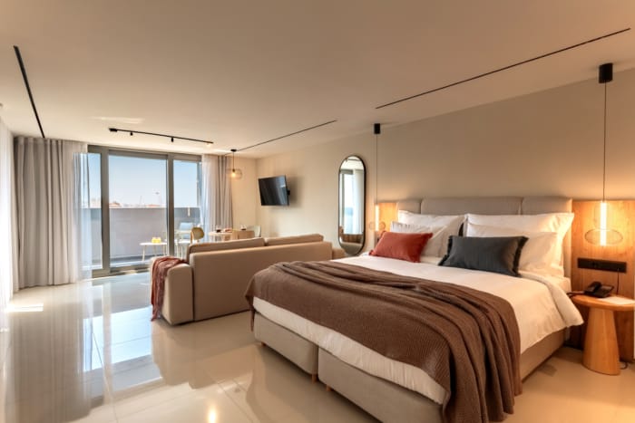 a bedroom with a bed and a television