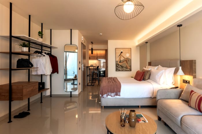 a bedroom with a bed and a couch