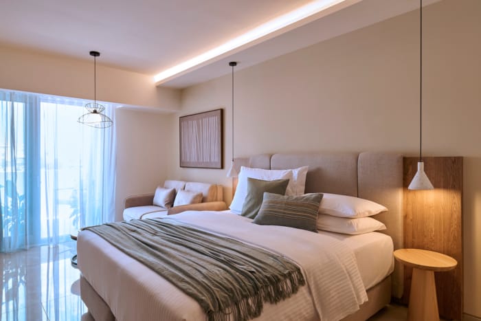 a bed with a couch and a lamp