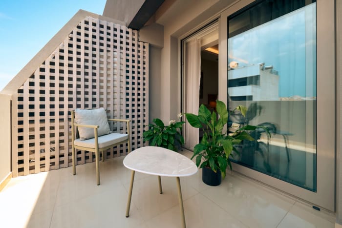 a chair and table on a balcony
