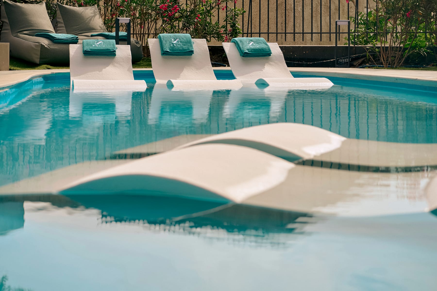 a pool with lounge chairs in it