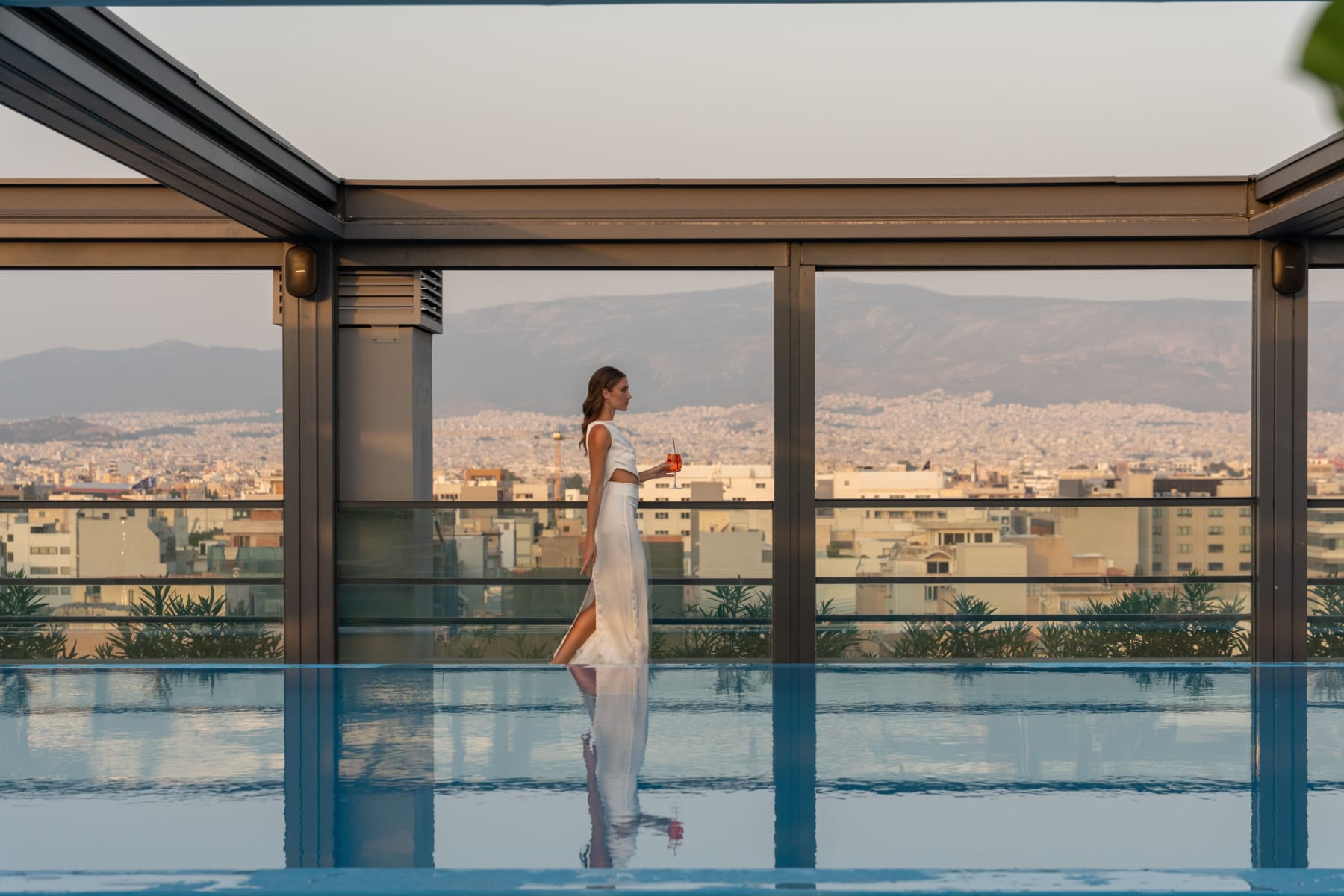a person in a white dress walking on a glass floor