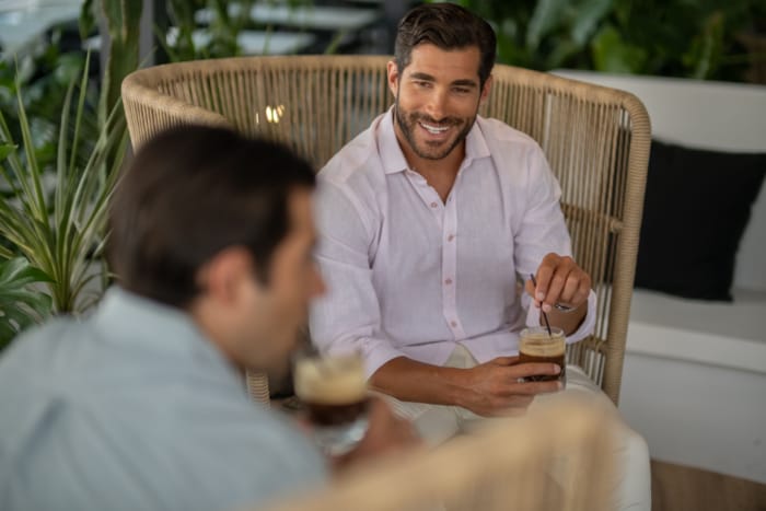 a person sitting in a chair and smiling