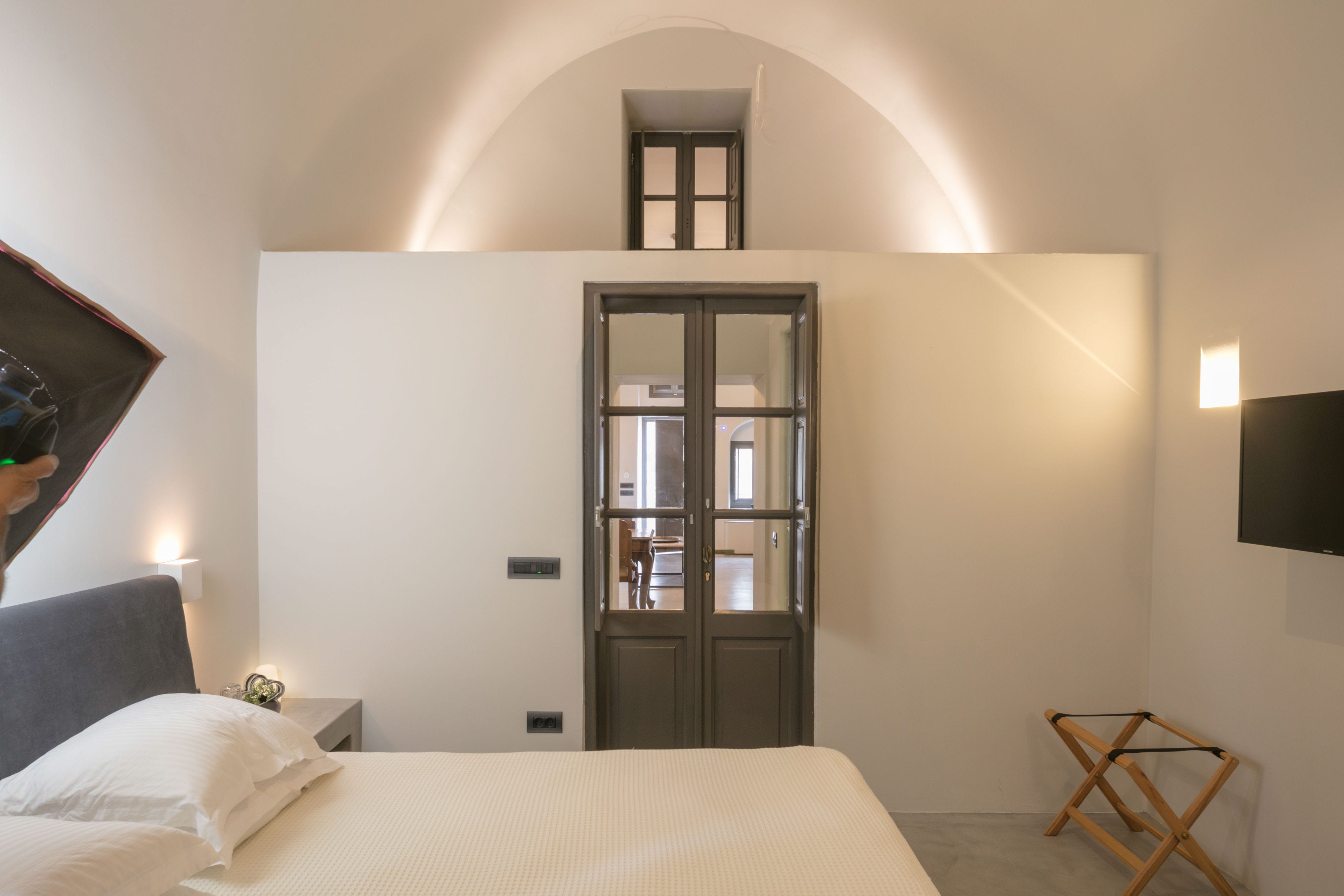 a bedroom with a bed and a glass door