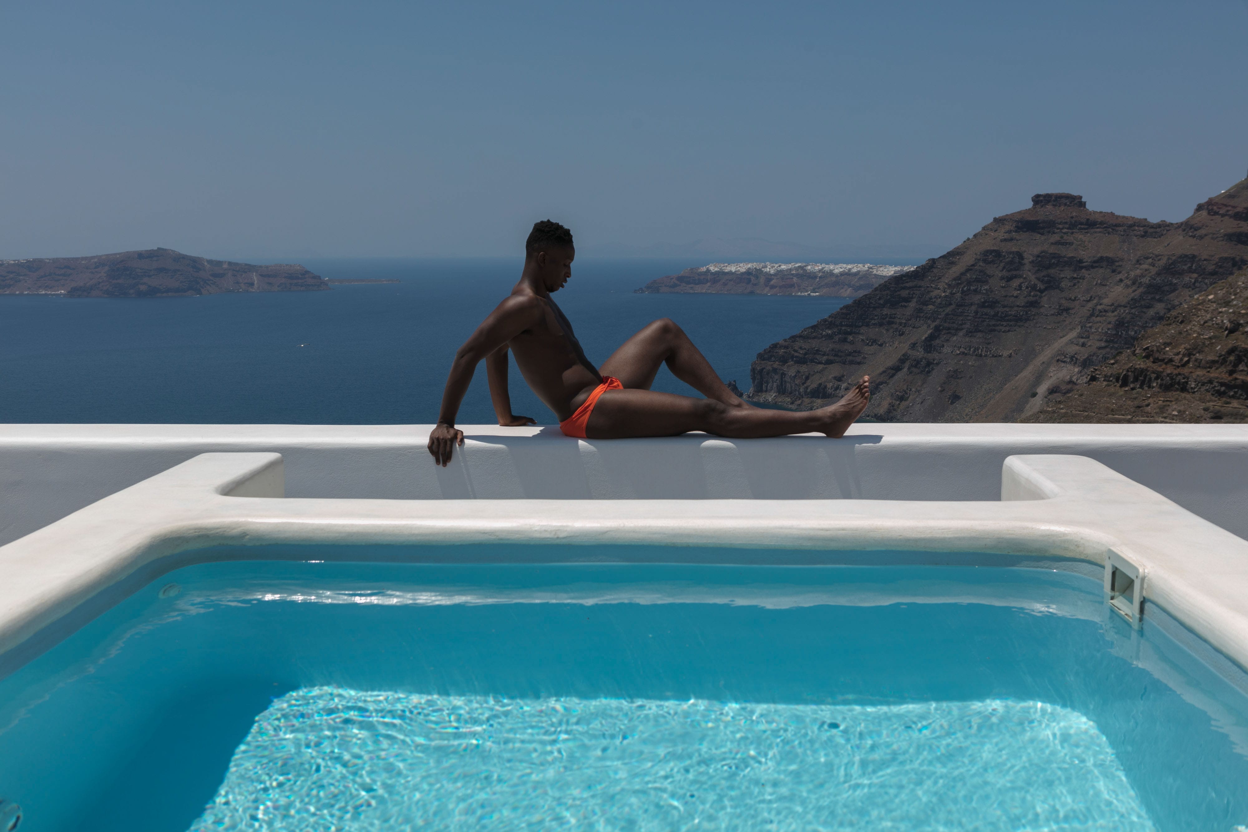 a person sitting on a pool edge