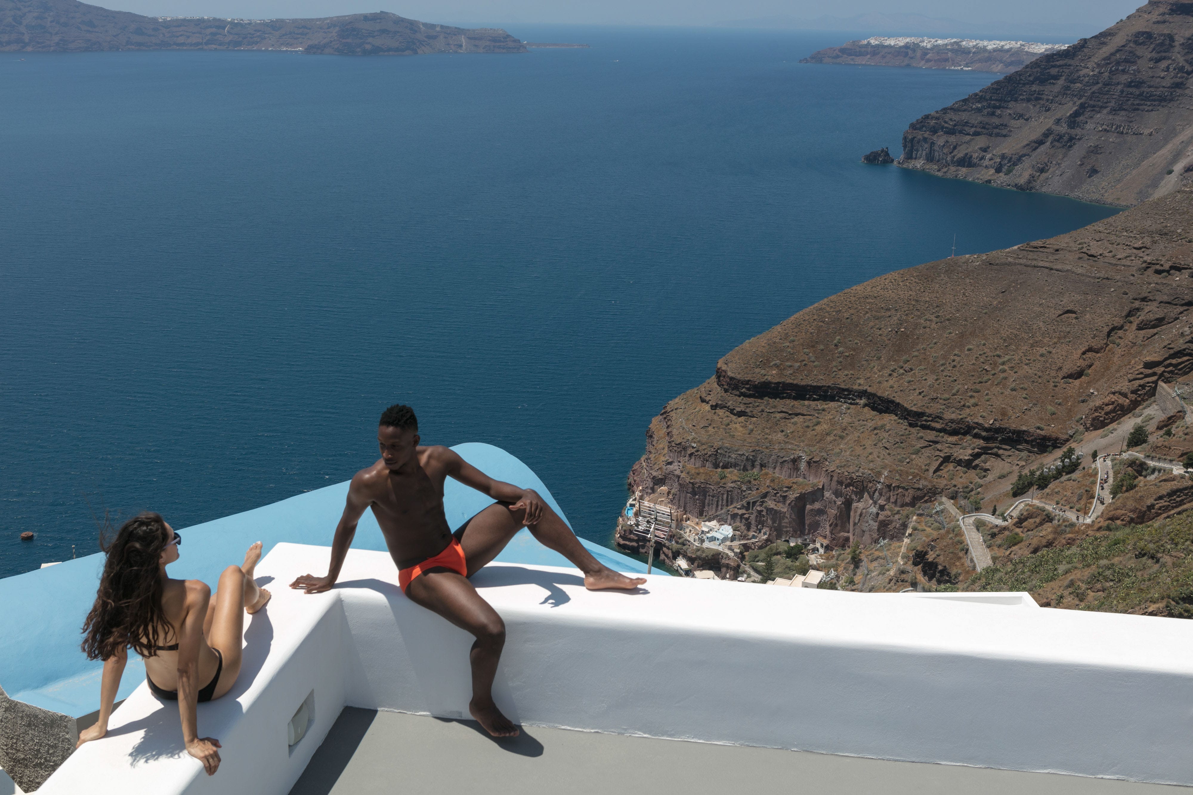 a group of people on a balcony overlooking the sea
