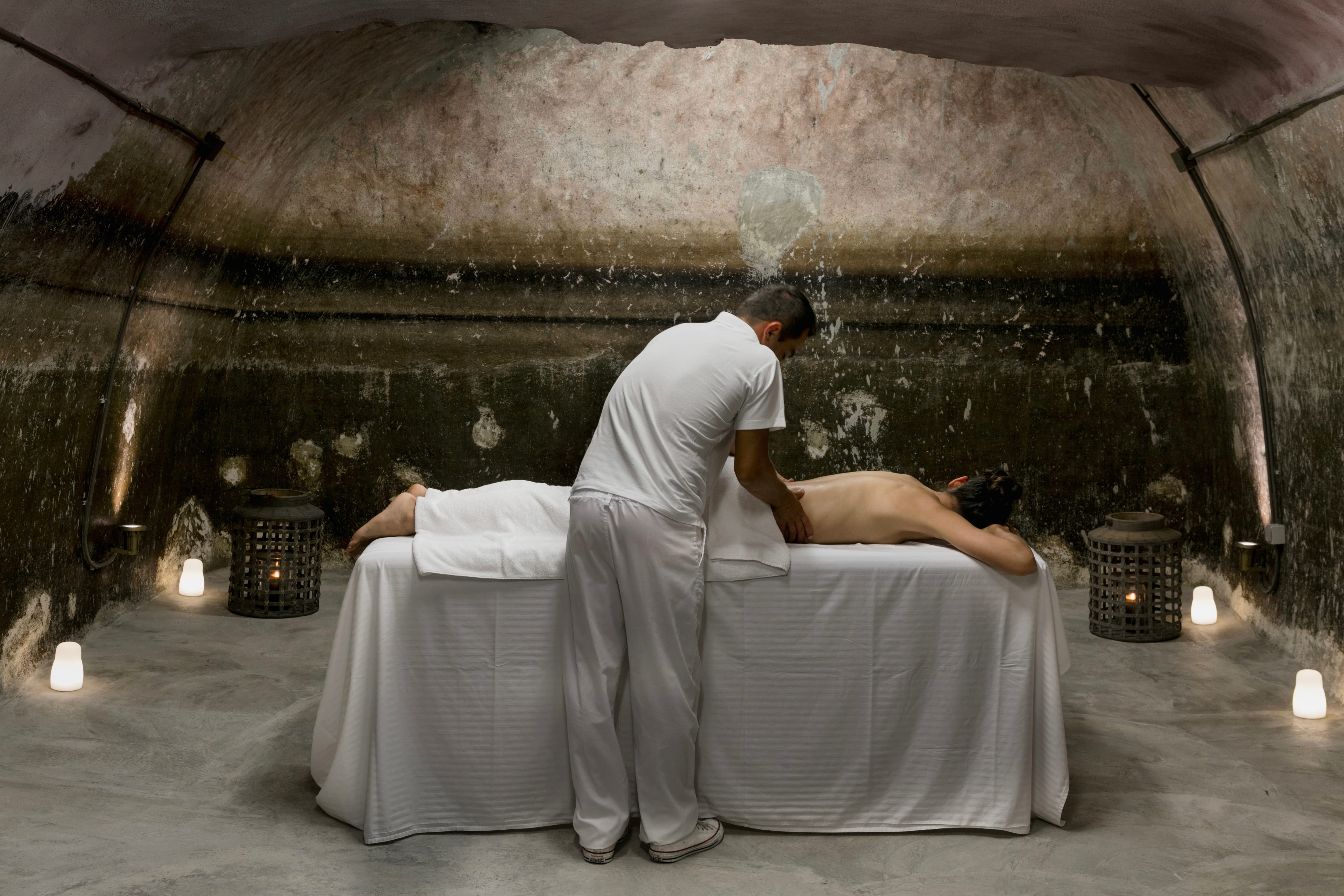 a person massaging a person's back