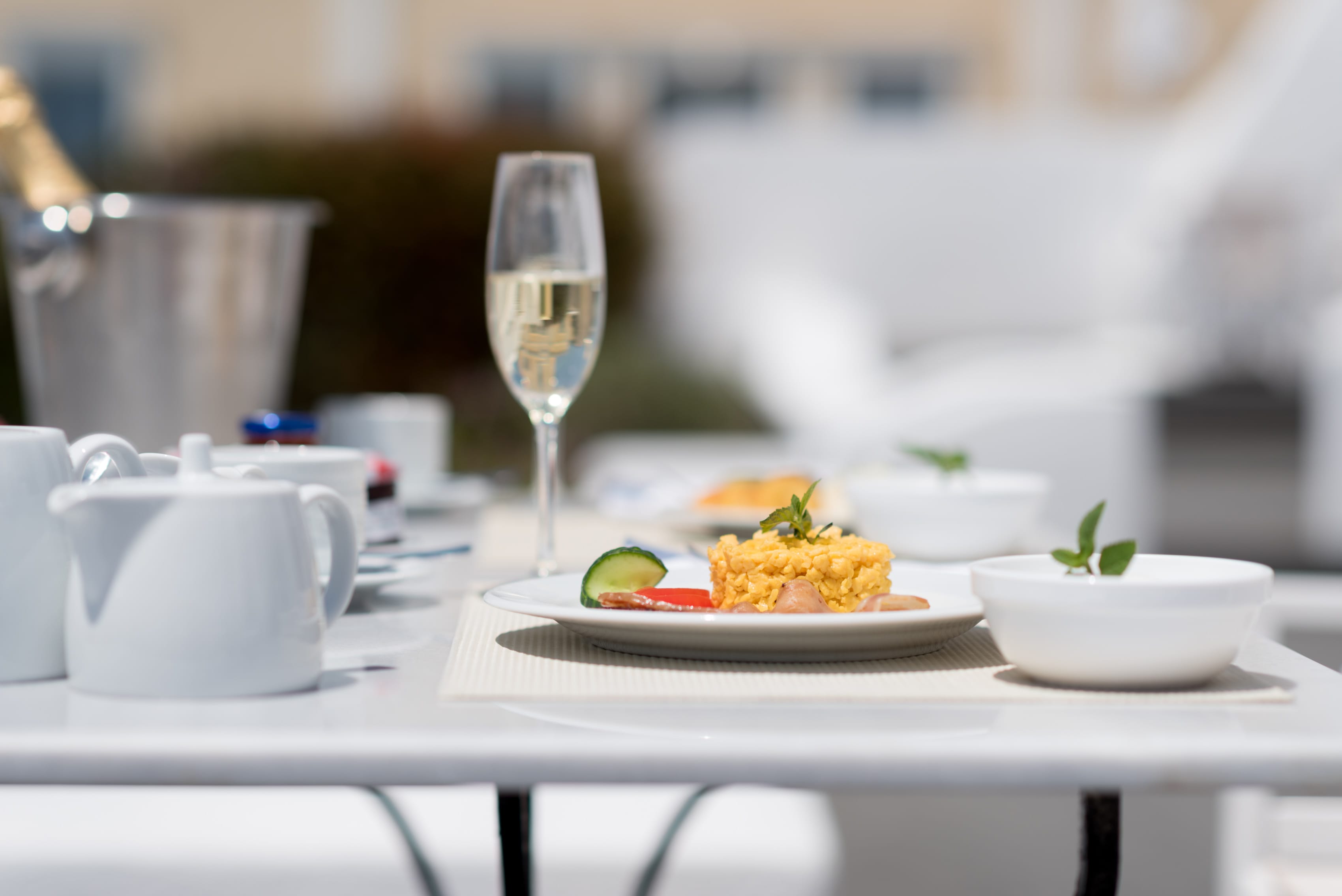 a table with plates of food and a glass of wine
