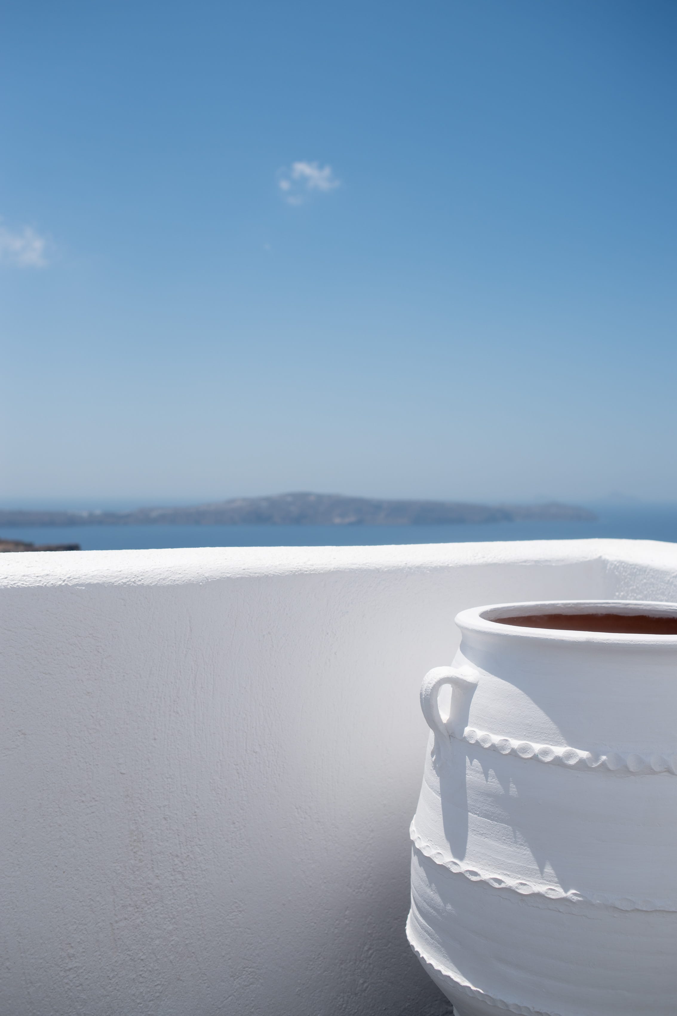 a white pot on a white wall