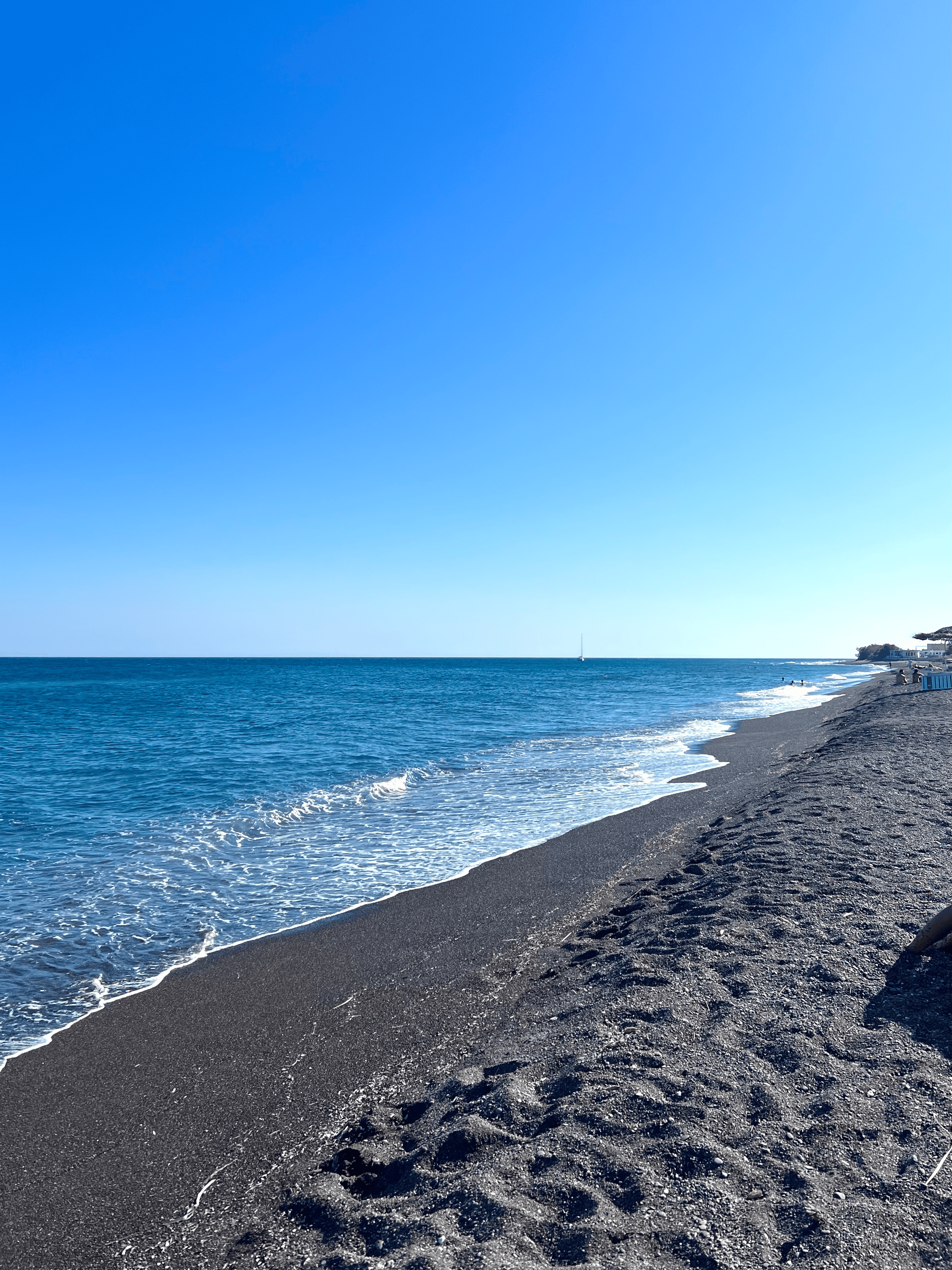a beach with umbrellas and water