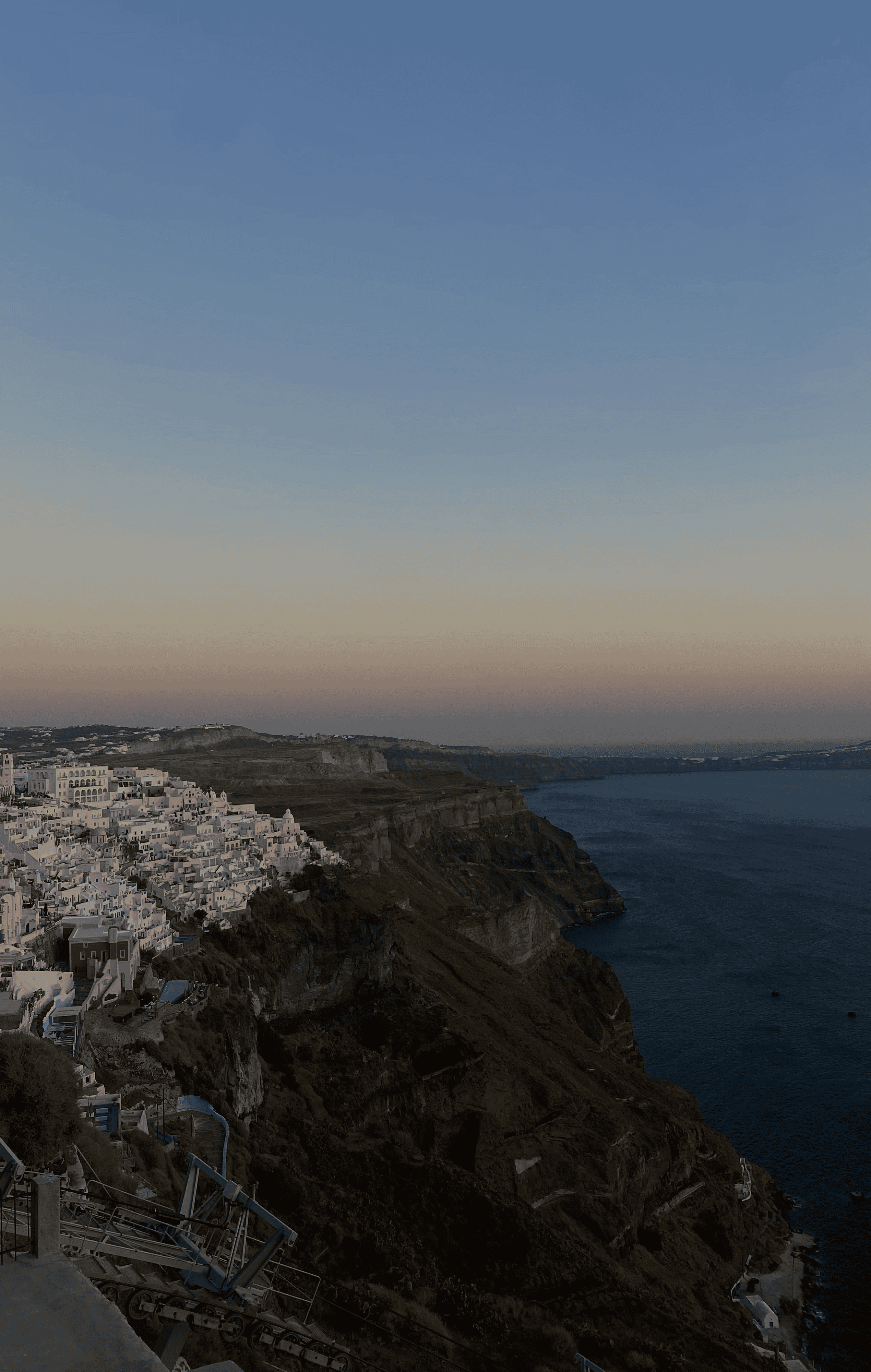 a city on a cliff by the ocean