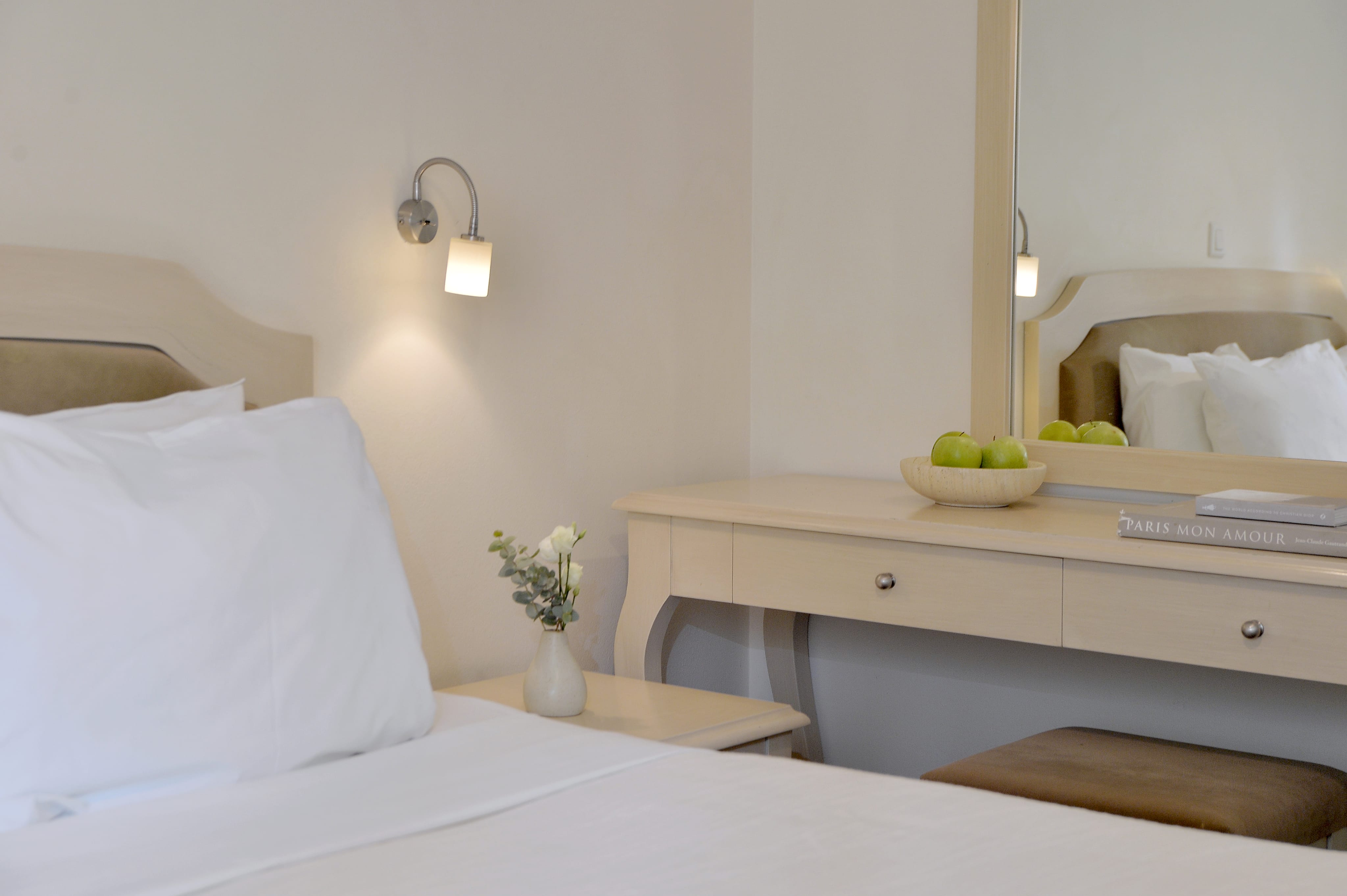 a white bed with a white pillow