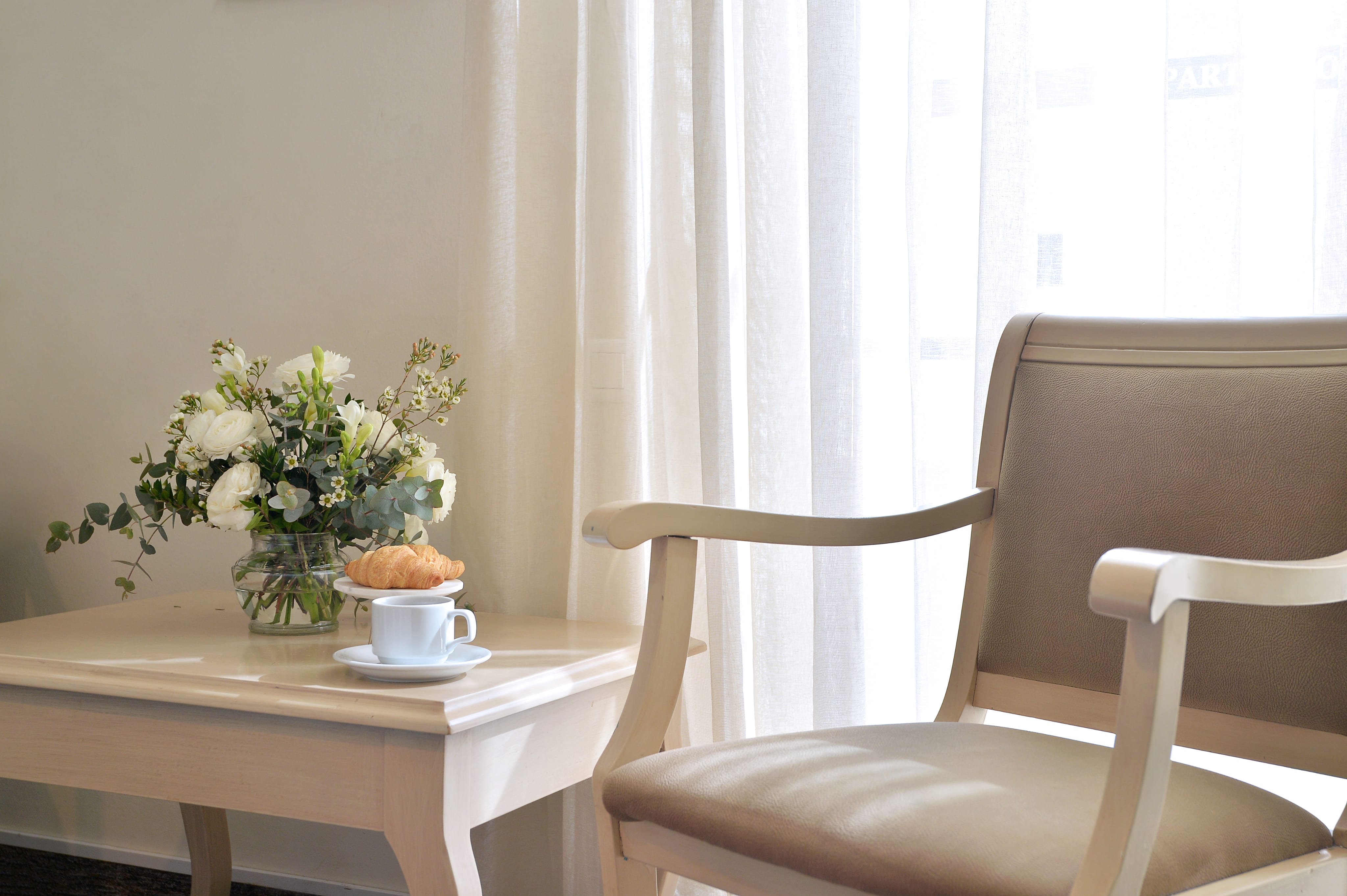 a chair and a cup of tea on a table