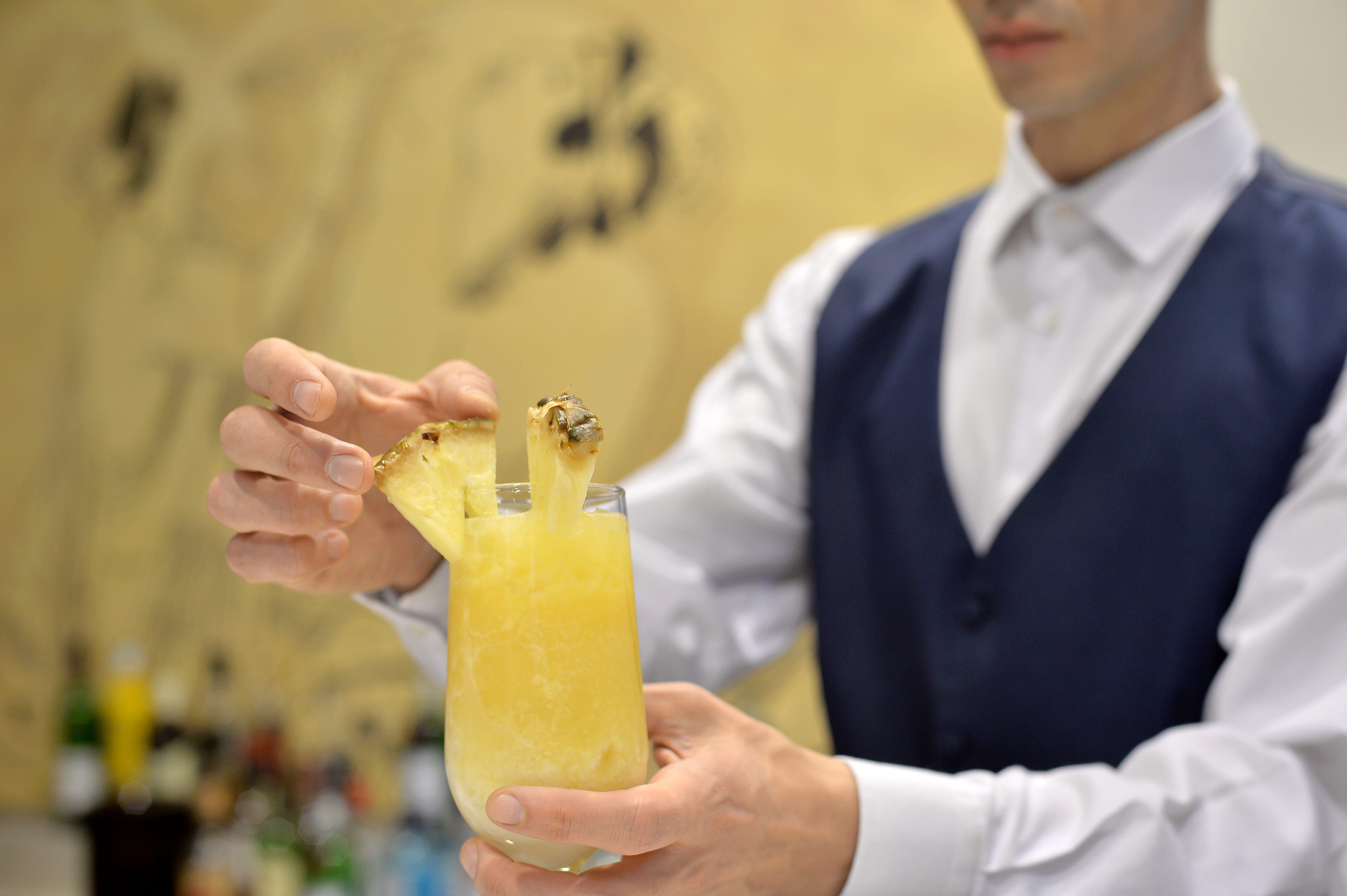 a person holding a glass of juice