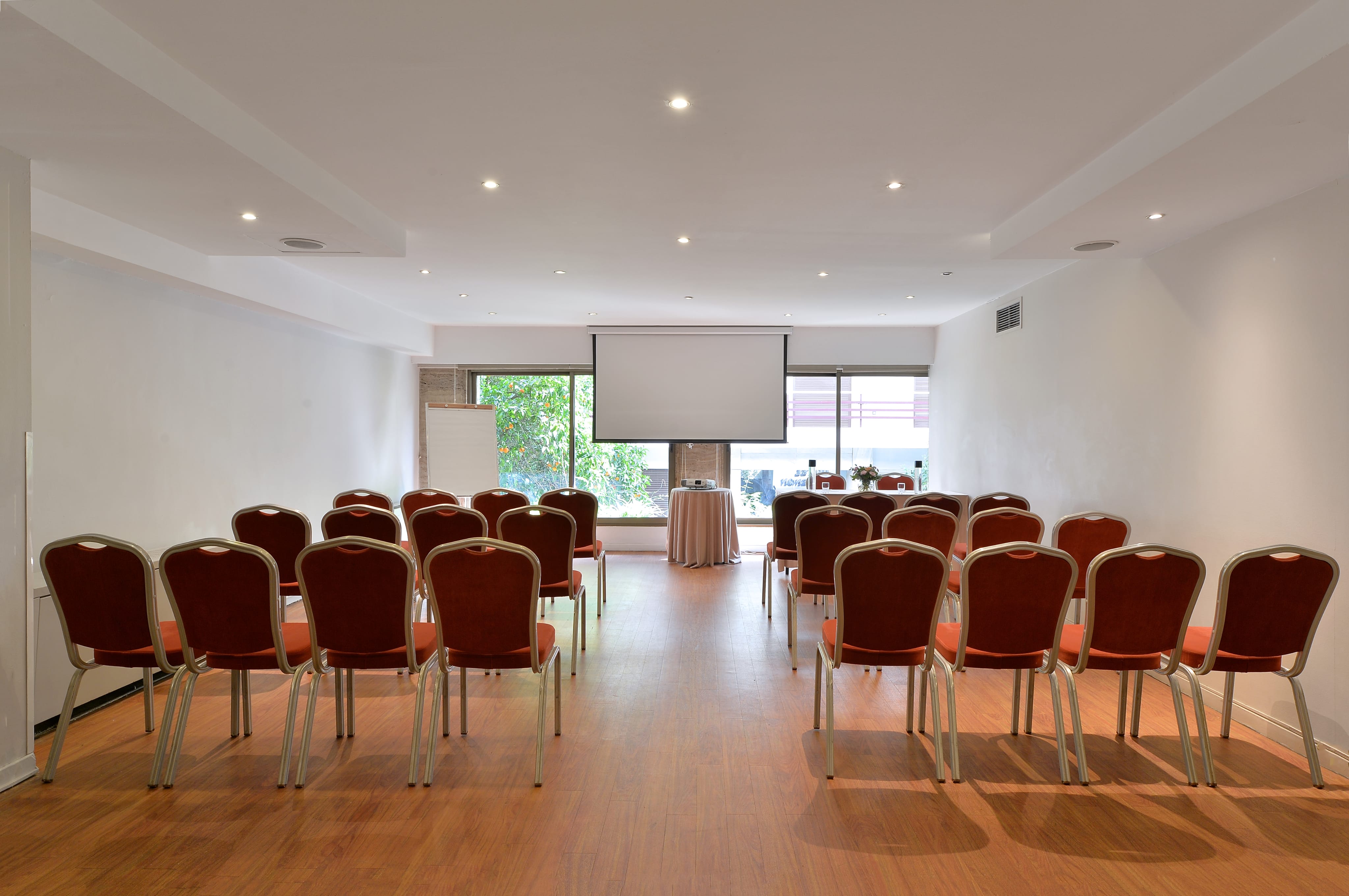 a room with chairs and a projector screen