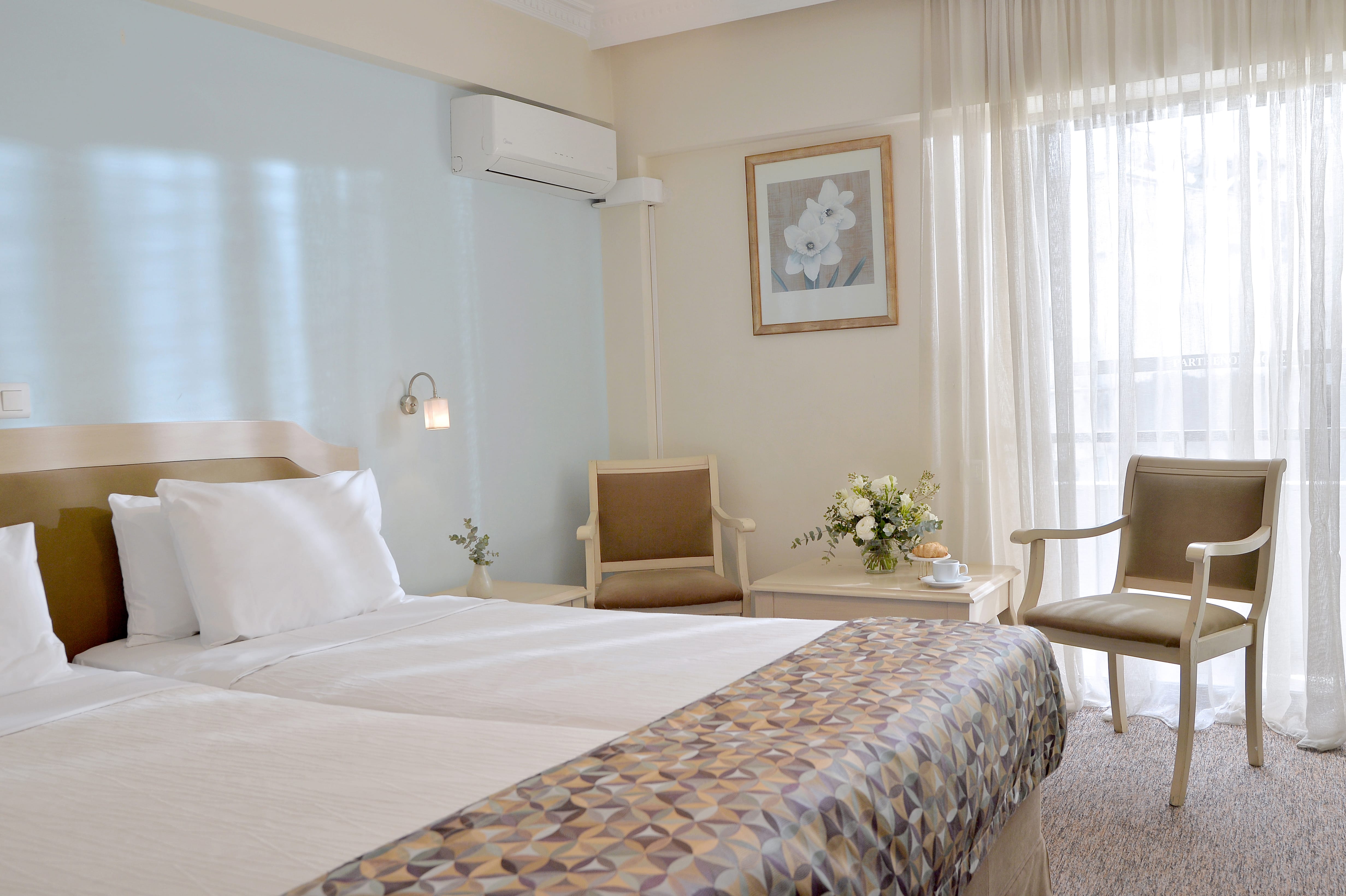 a hotel room with a bed and chair