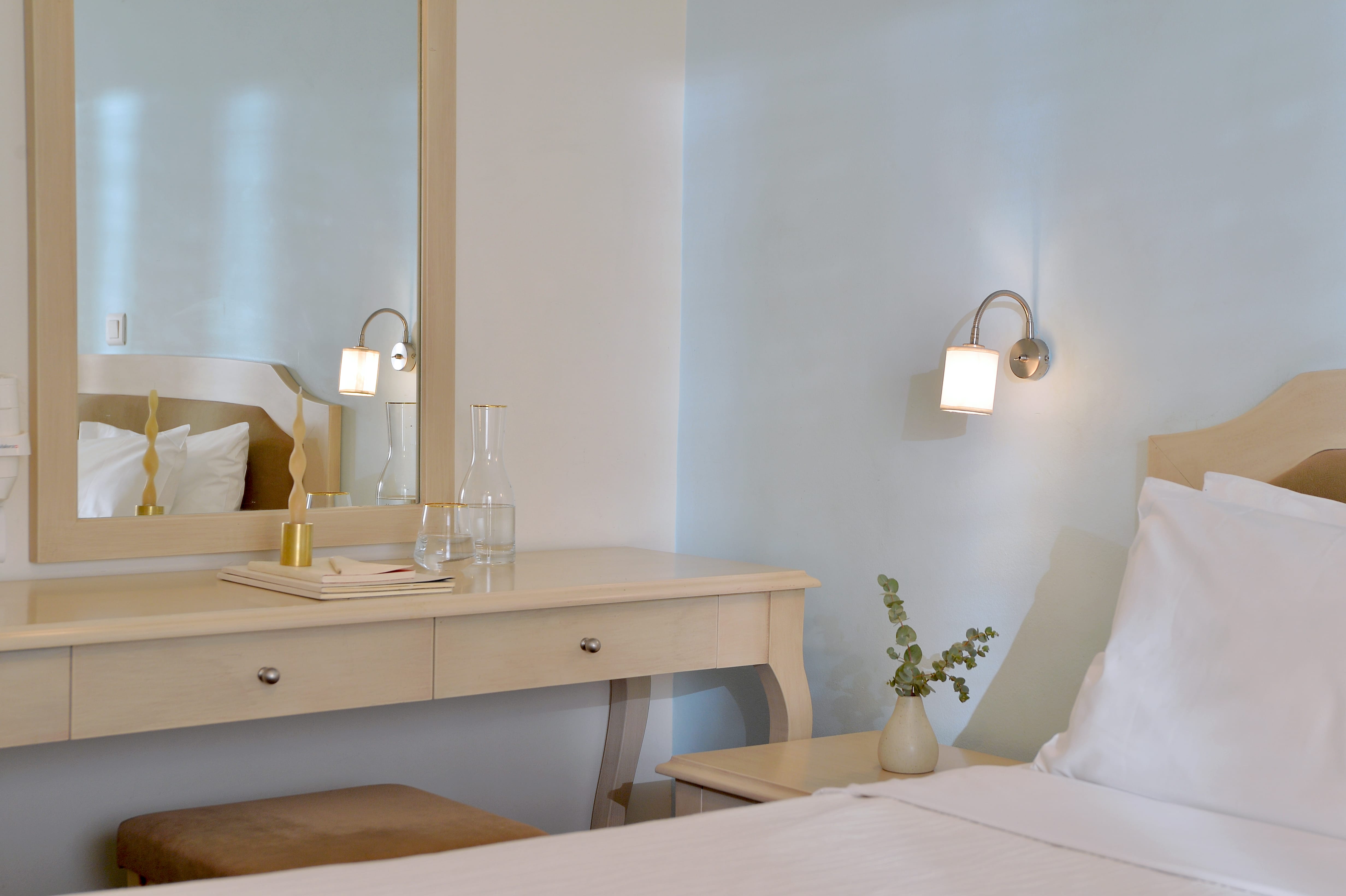 a bedroom with a mirror and a table