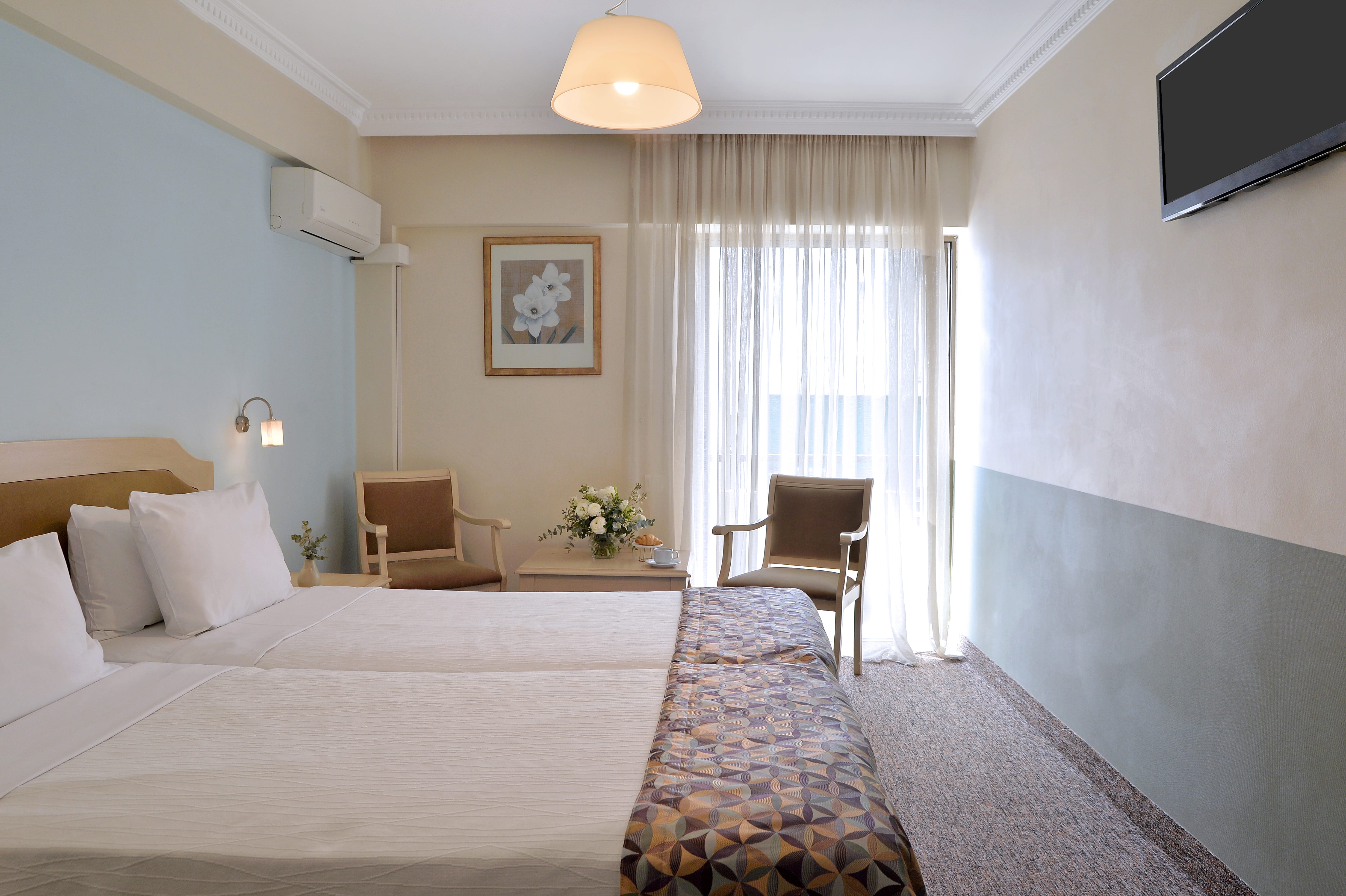 a hotel room with a bed and chair