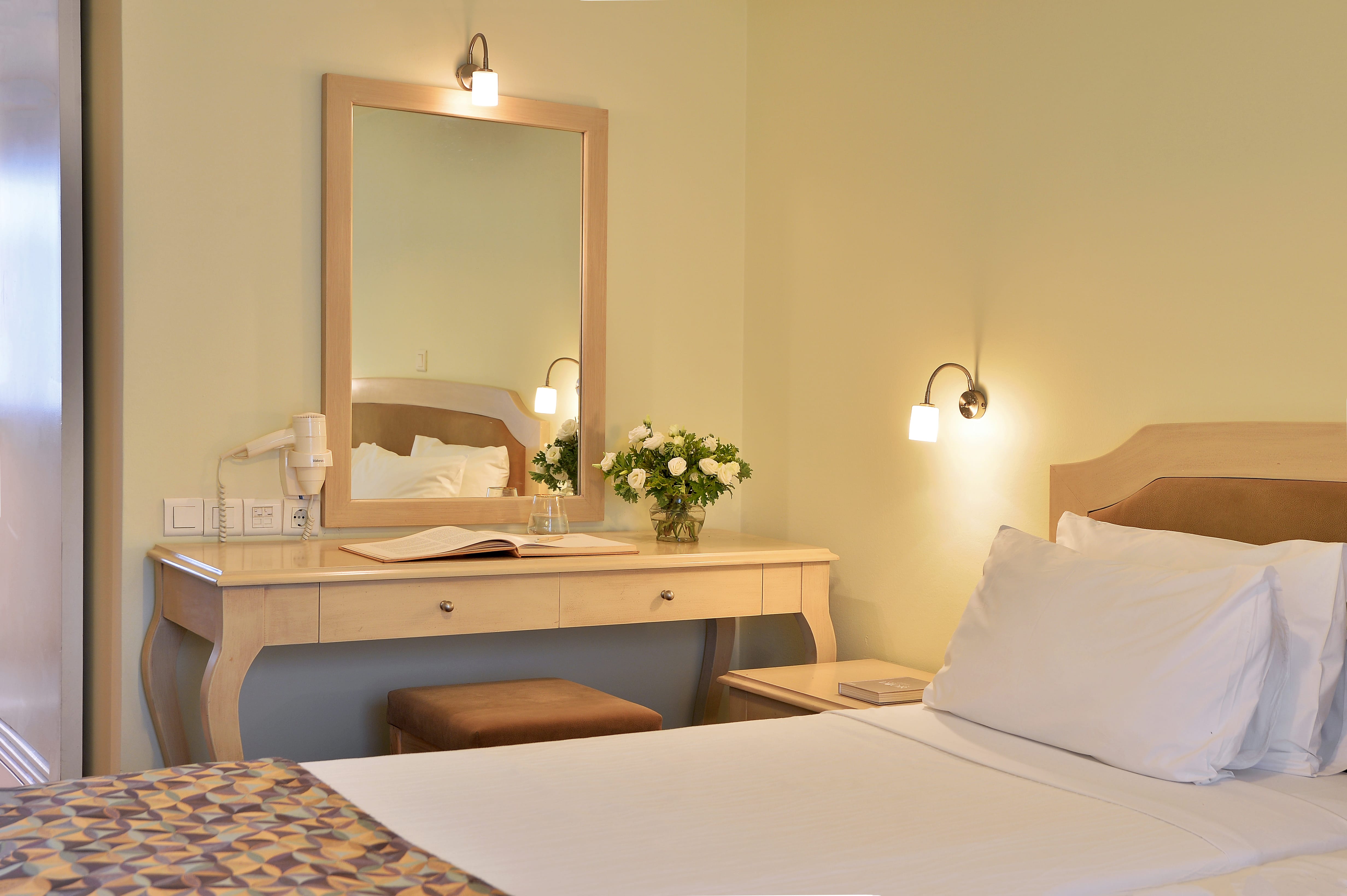 a bedroom with a mirror and a bed