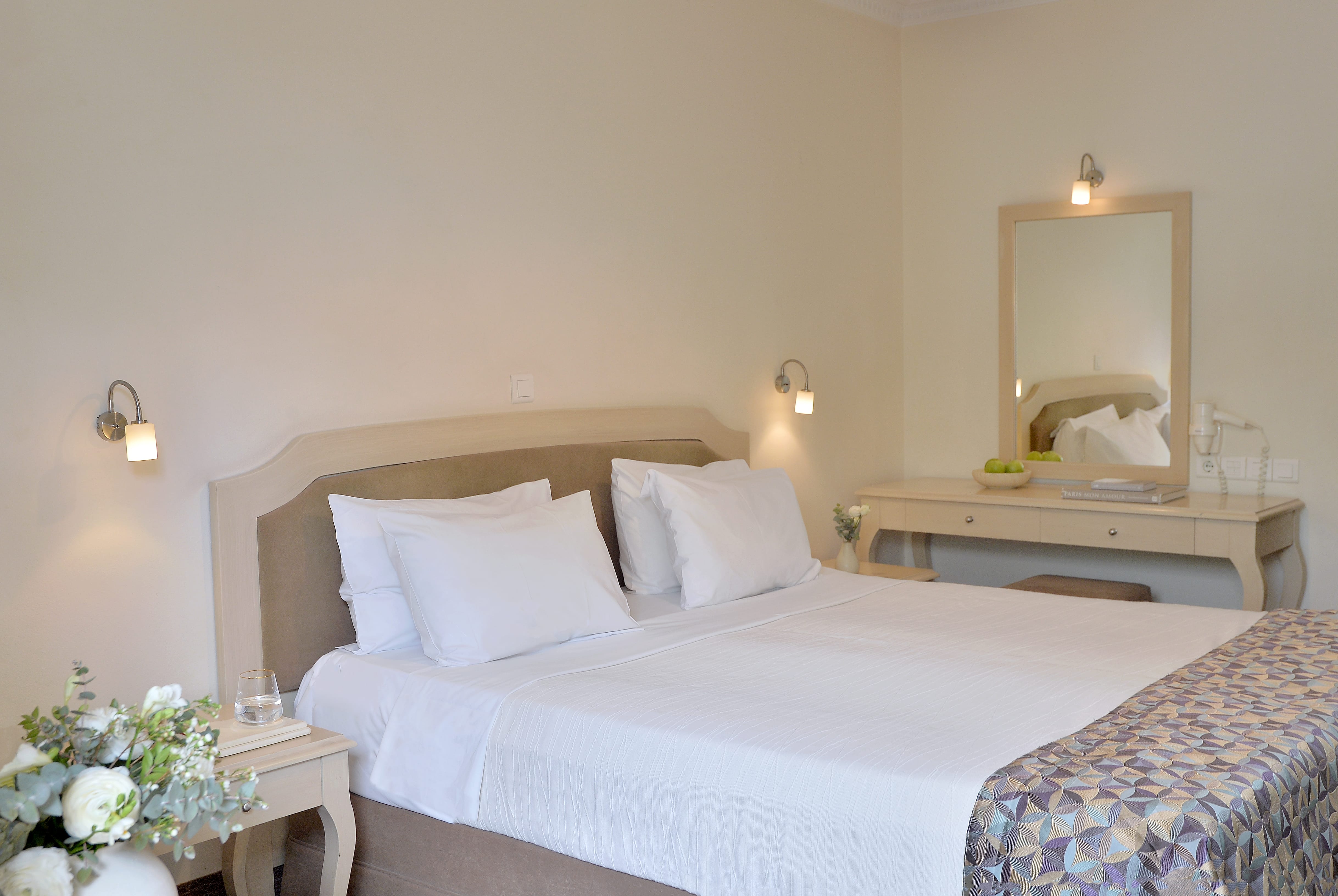 a bed with white sheets and pillows