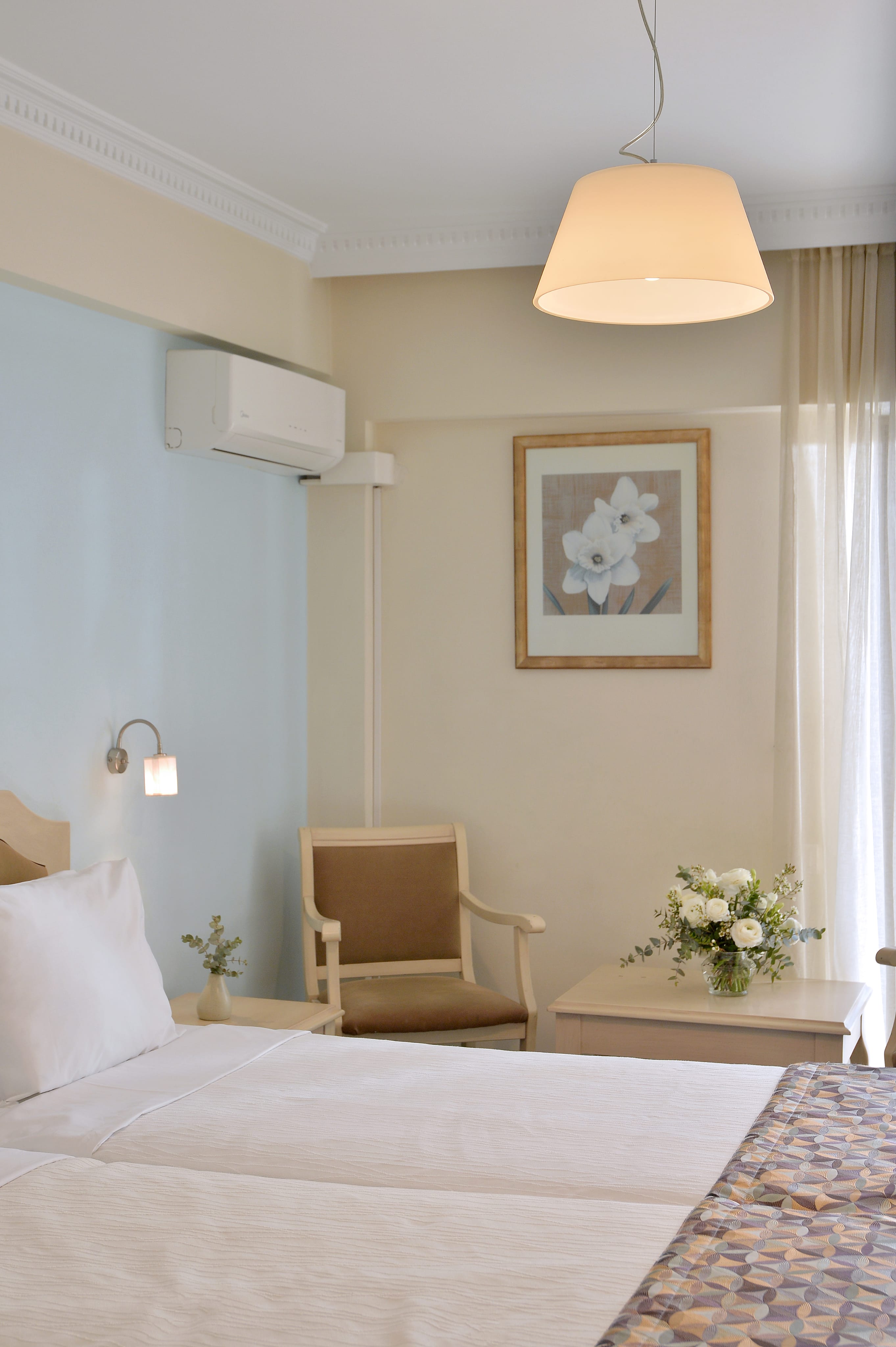 a bedroom with a bed and a chair