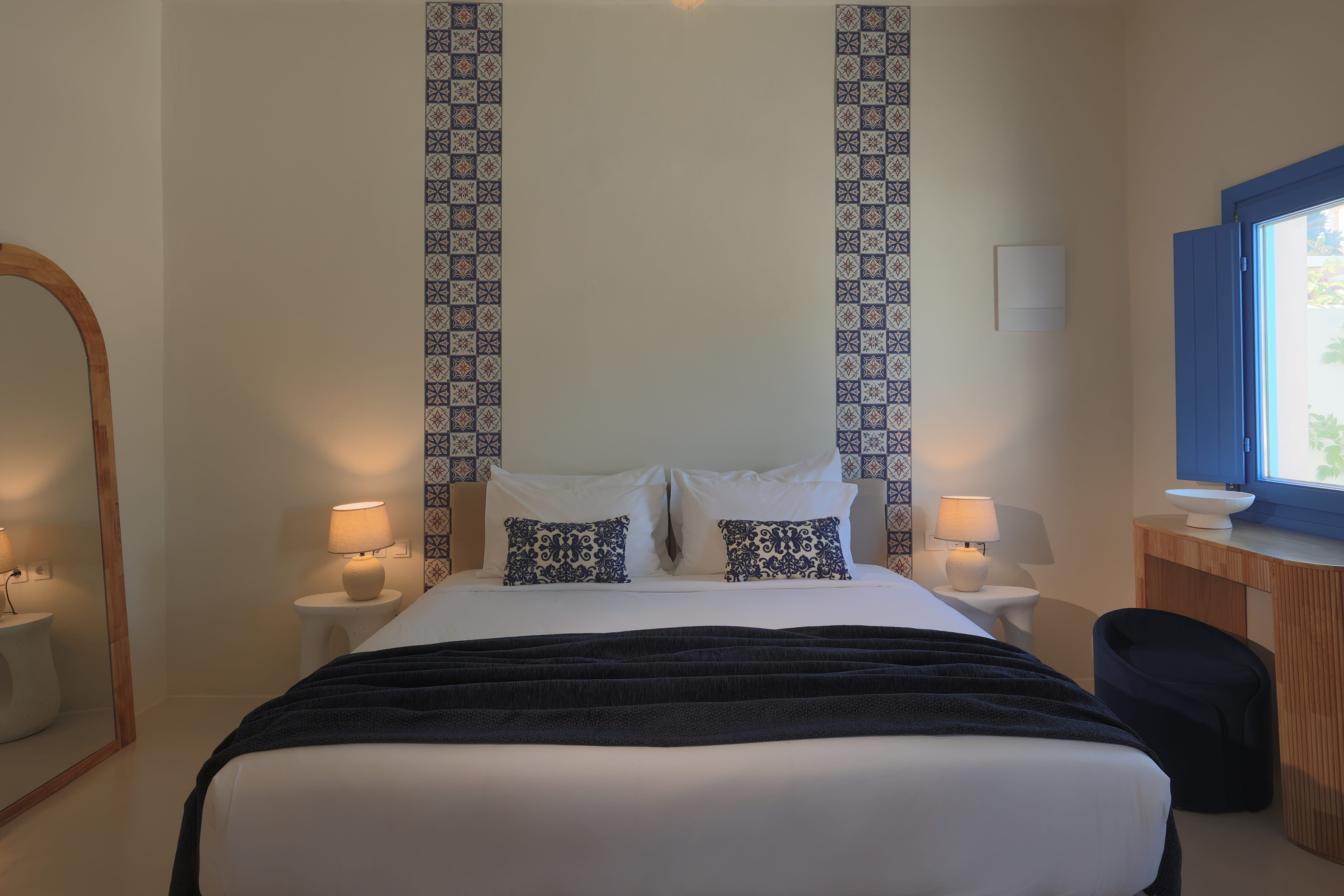 a bed with a black blanket and pillows