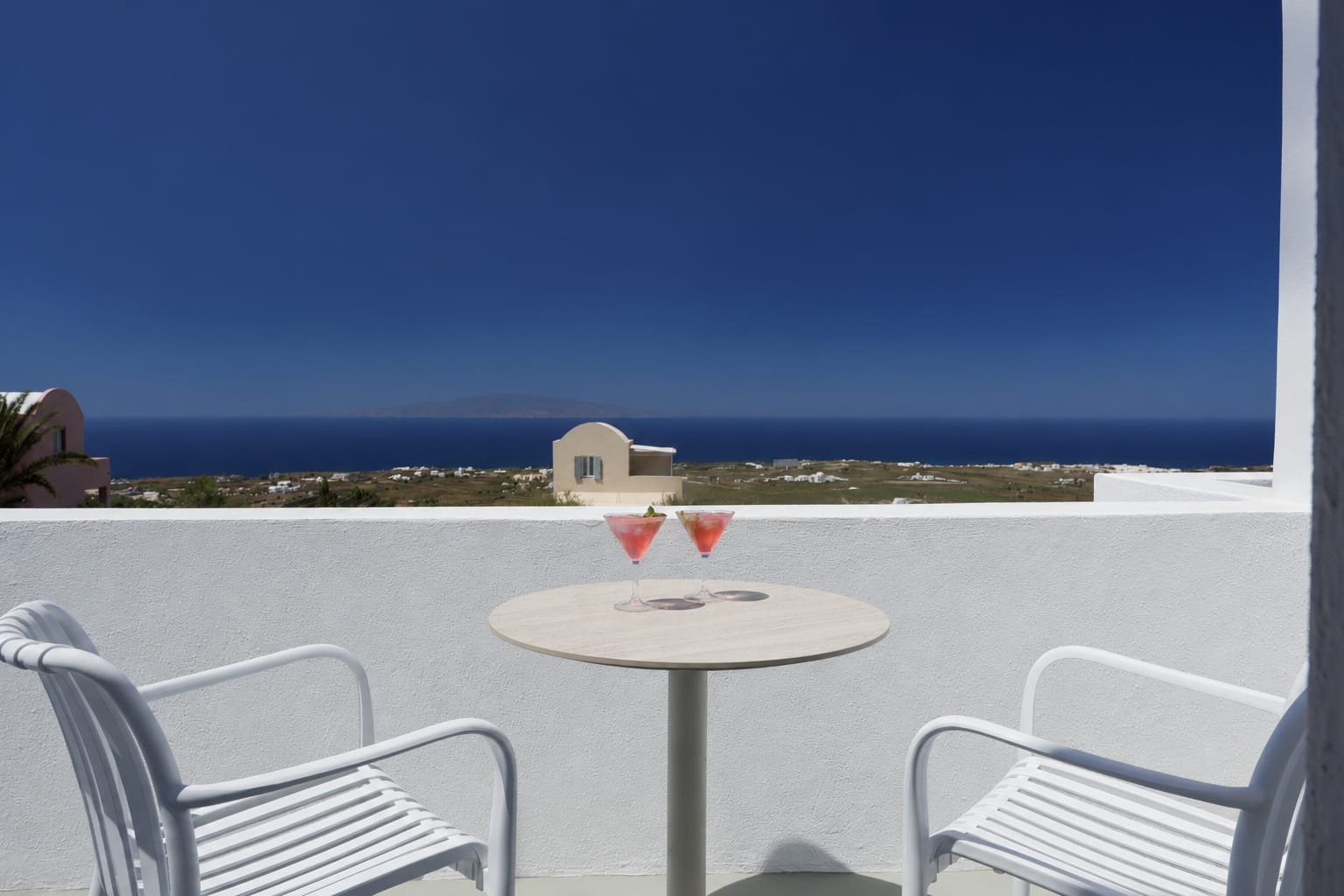 a table and chairs on a balcony