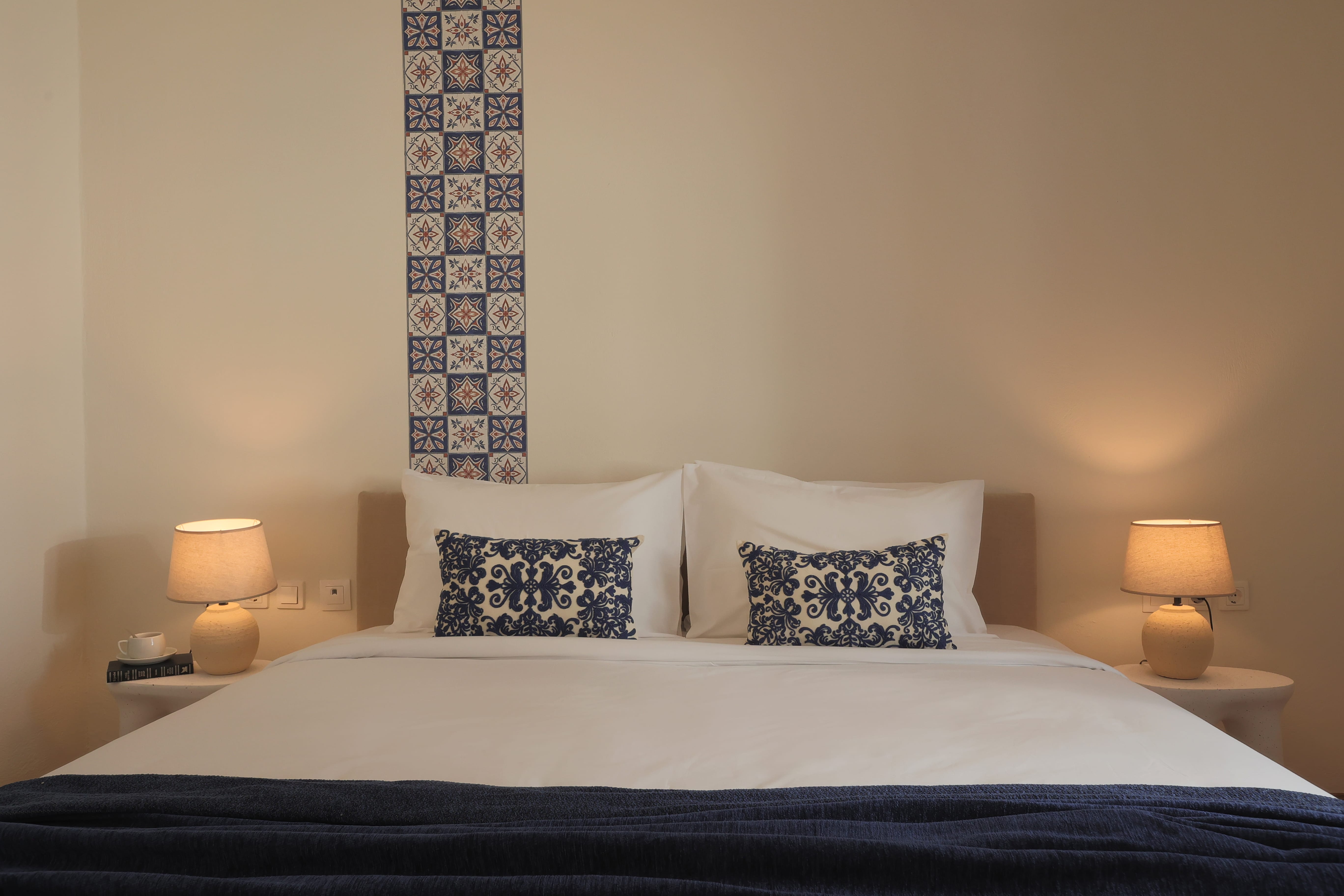 a bed with two lamps