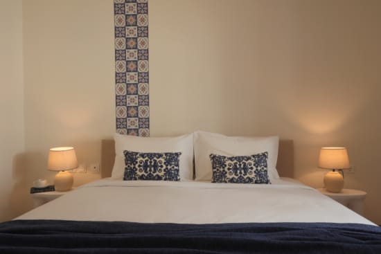 a bed with two lamps
