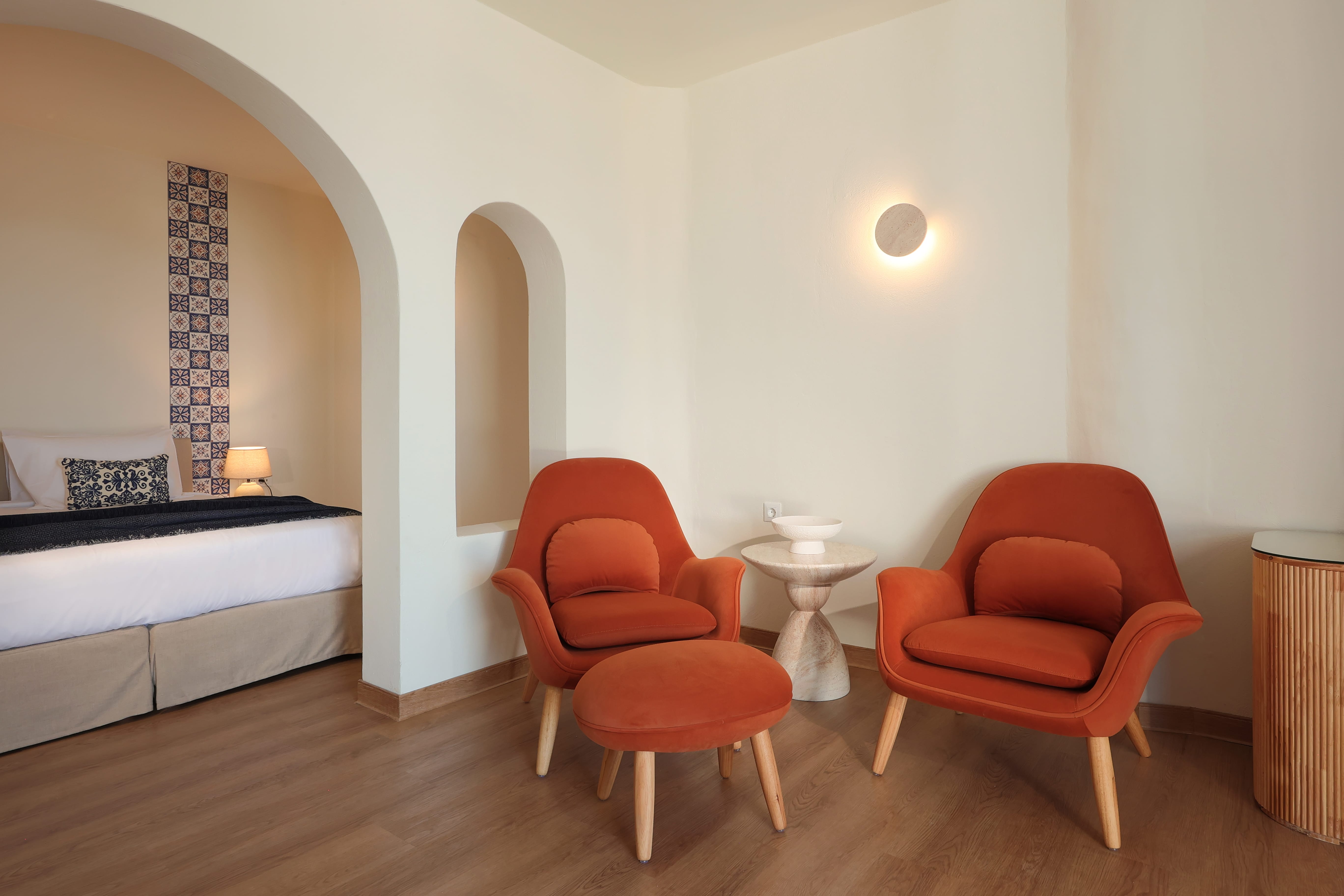 a room with orange chairs and a bed