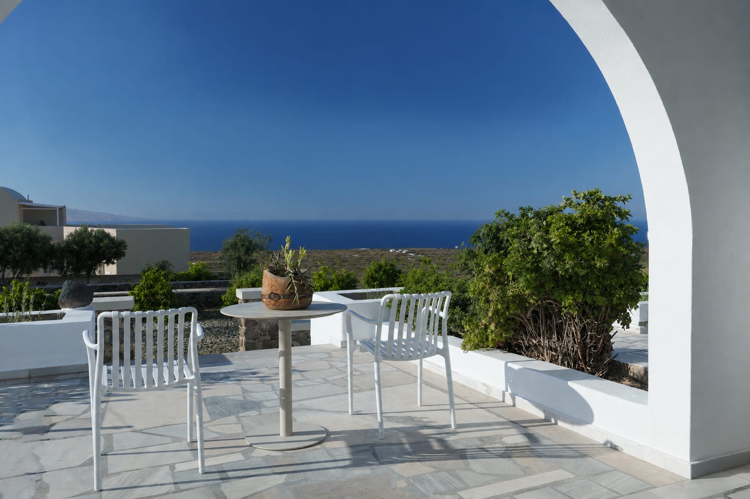 a patio with chairs and a table