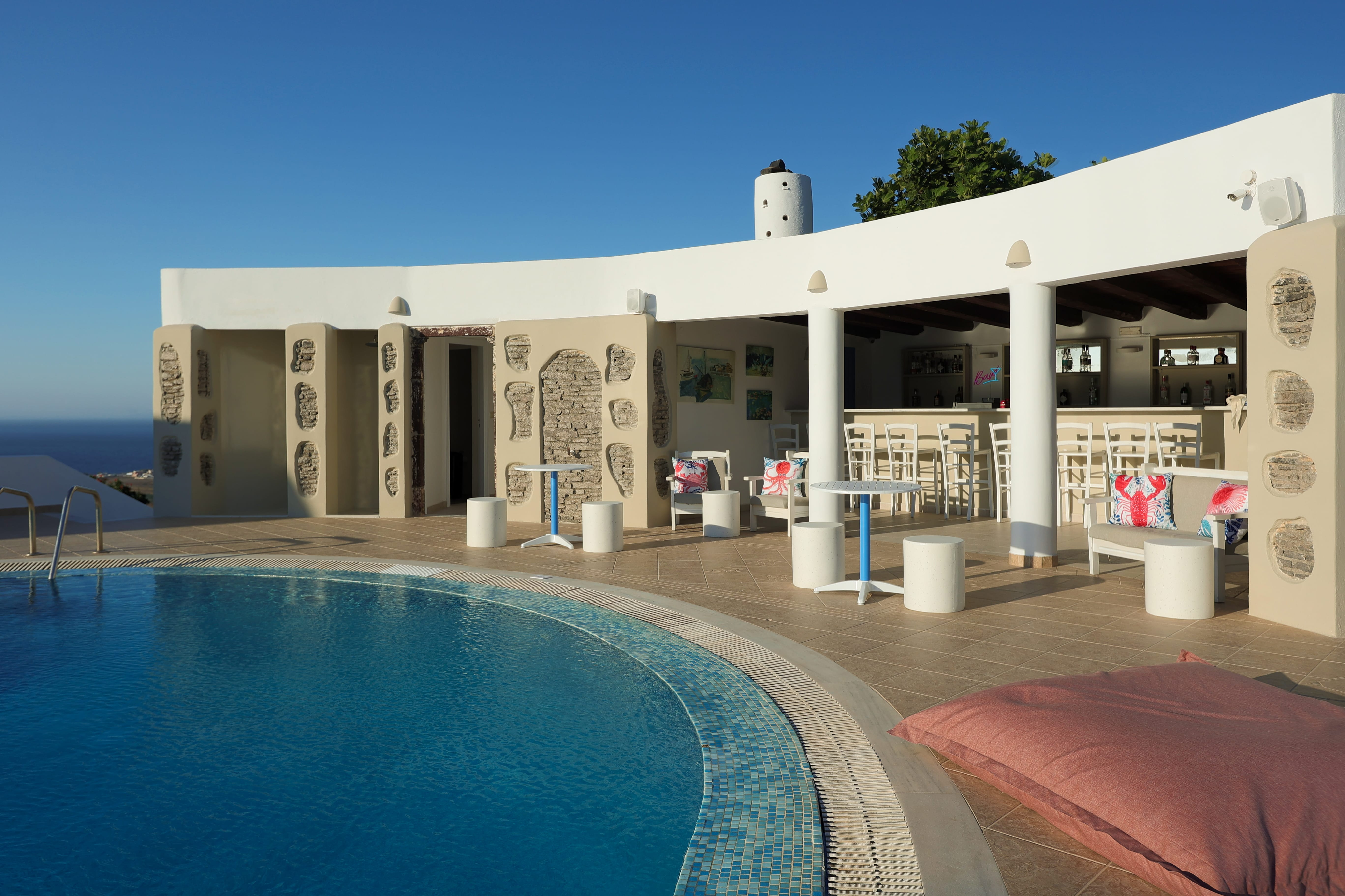 a pool with a white building