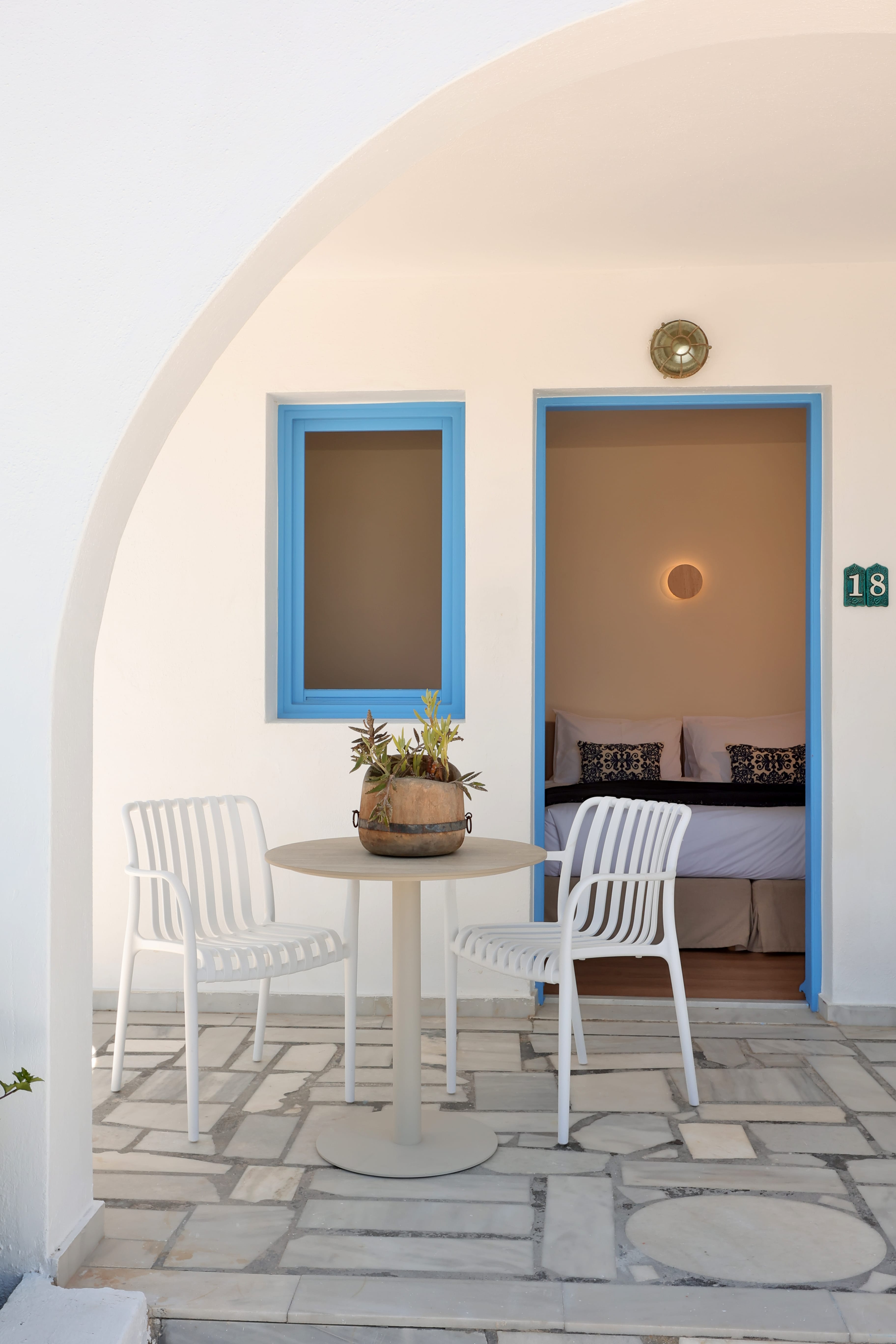a table and chairs in front of a bedroom