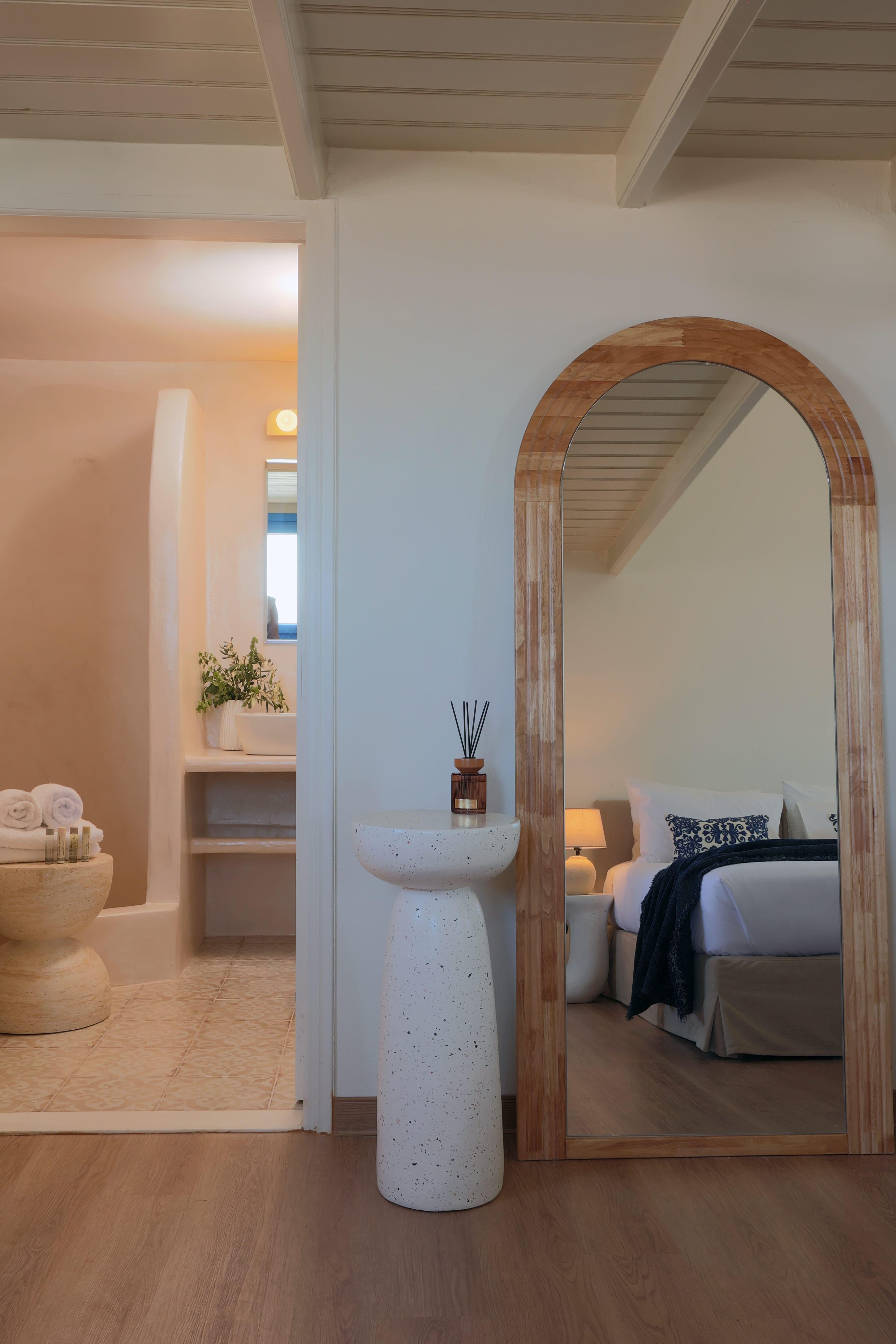 a mirror next to a bed