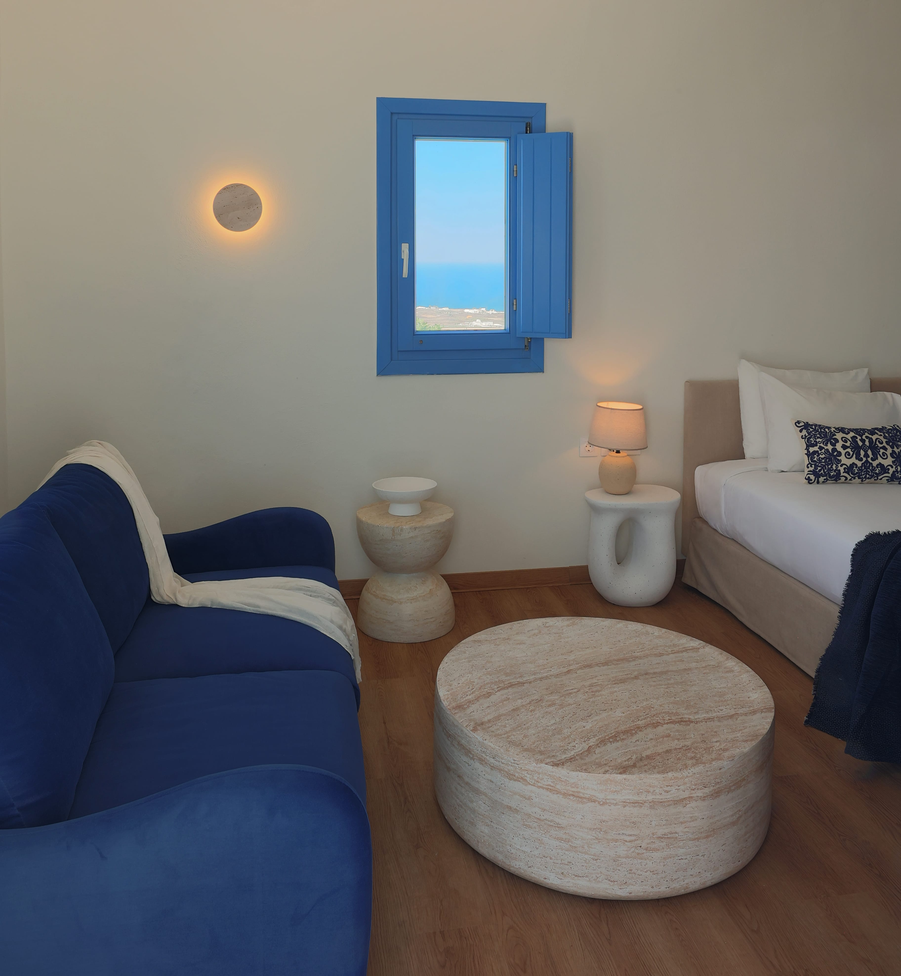 a room with a blue window and couch
