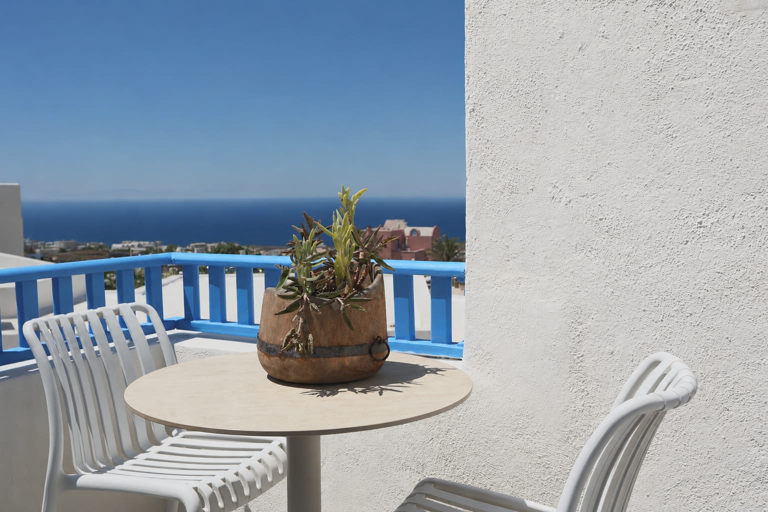a table with chairs and a plant on it