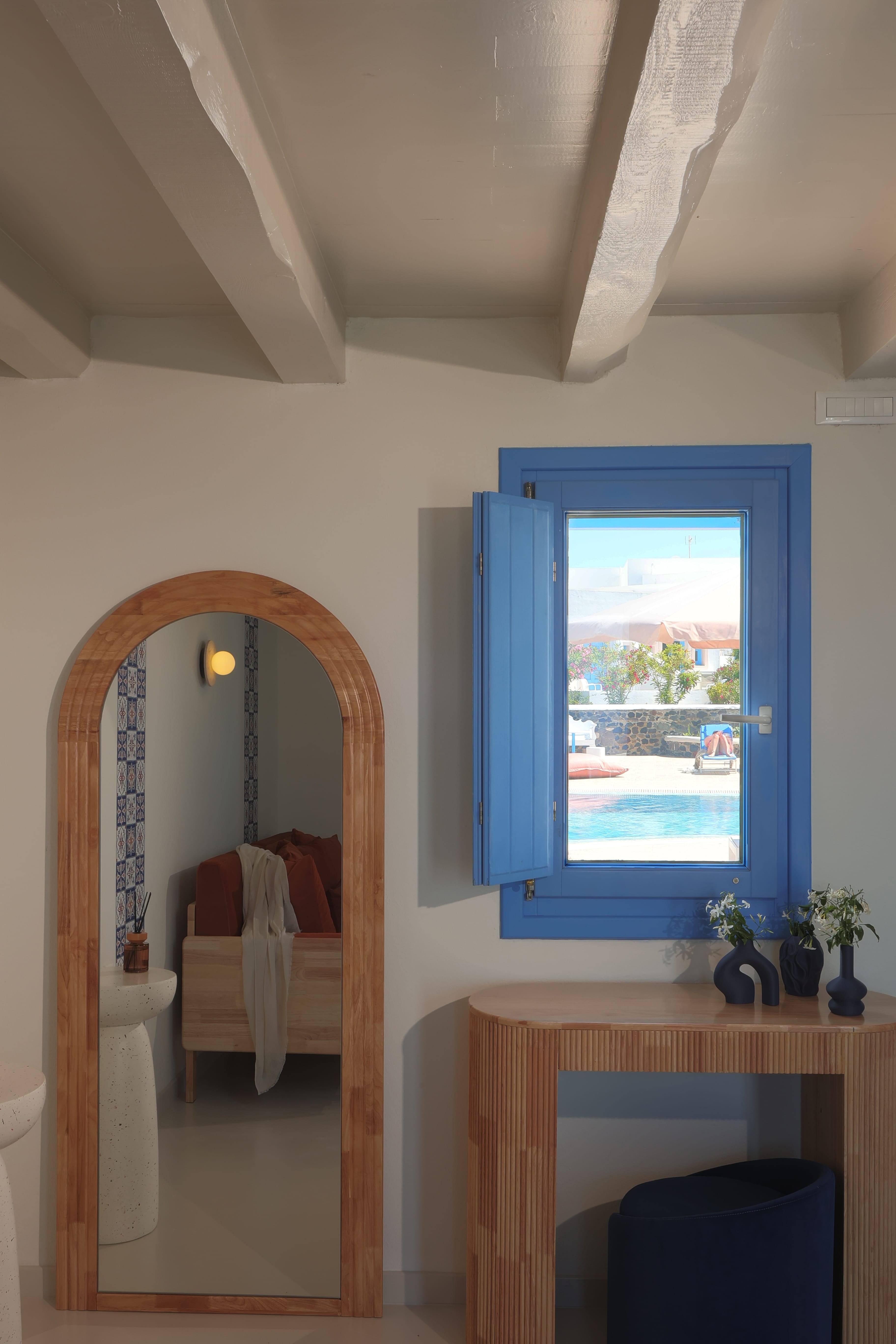 a blue window next to a mirror