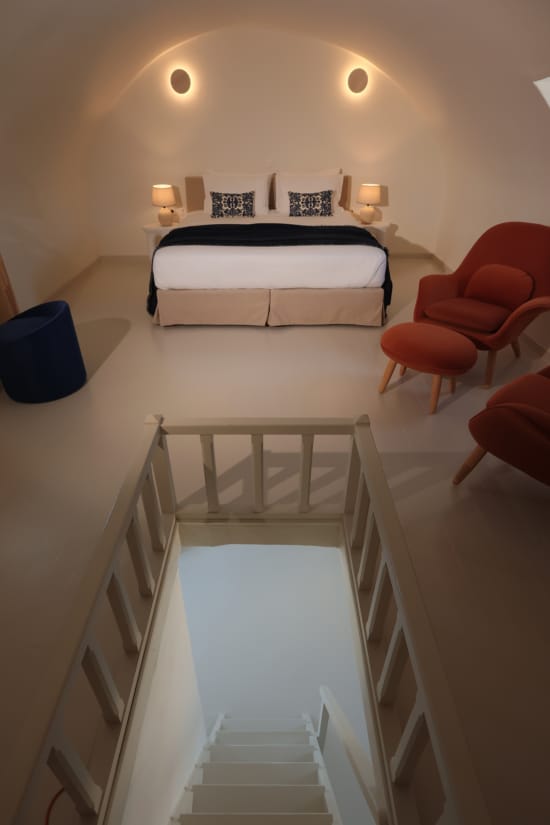 a bed and chairs in a room
