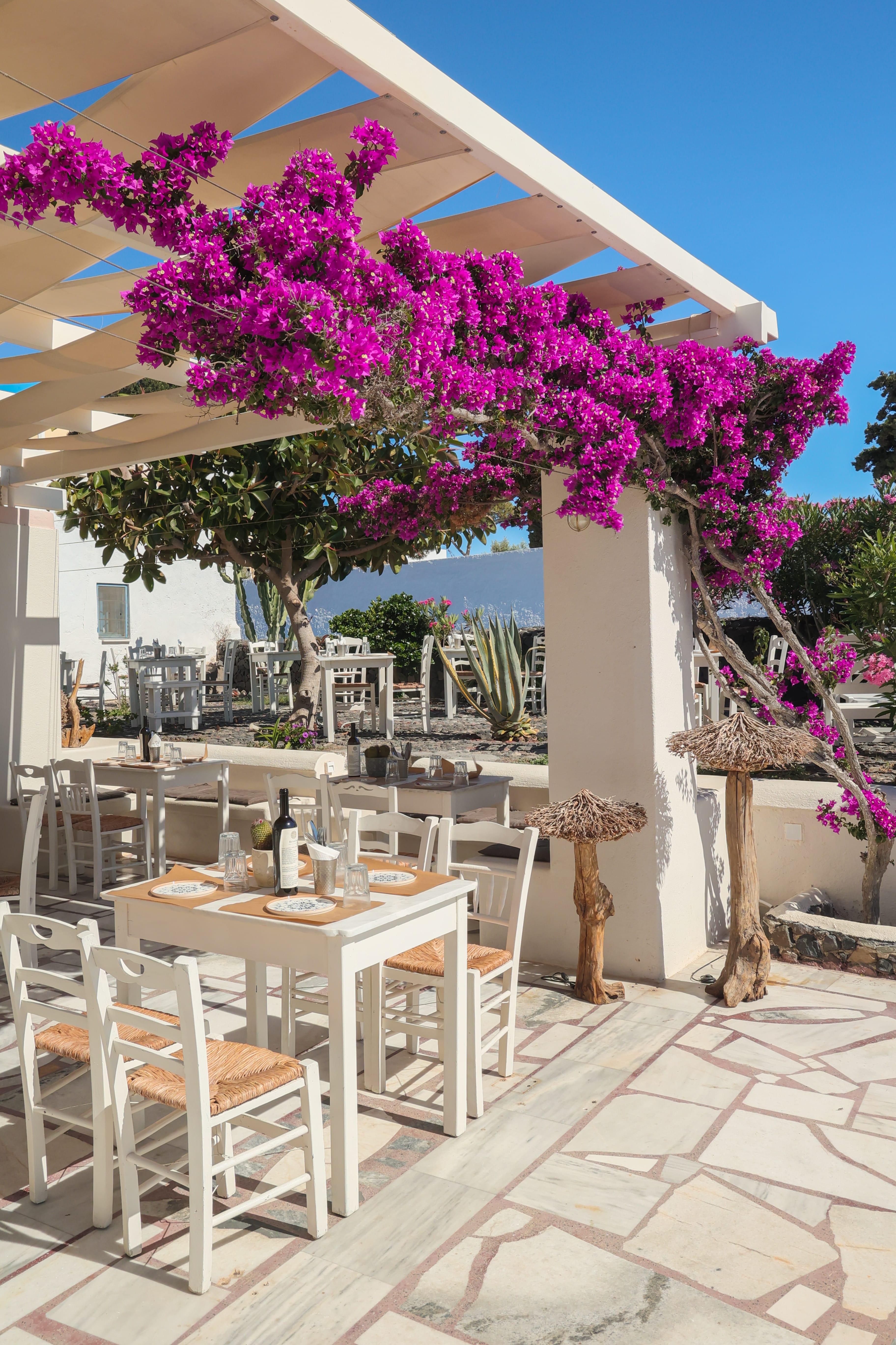a table and chairs under a pergola