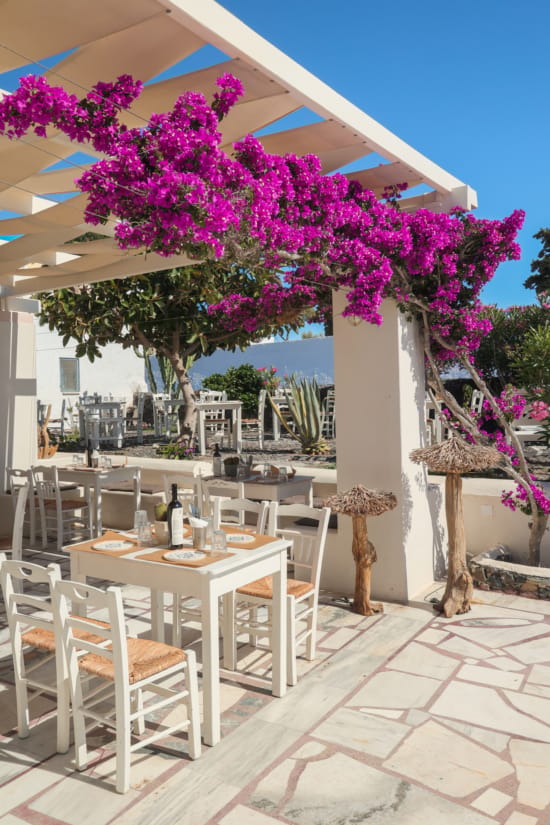 a table and chairs under a pergola