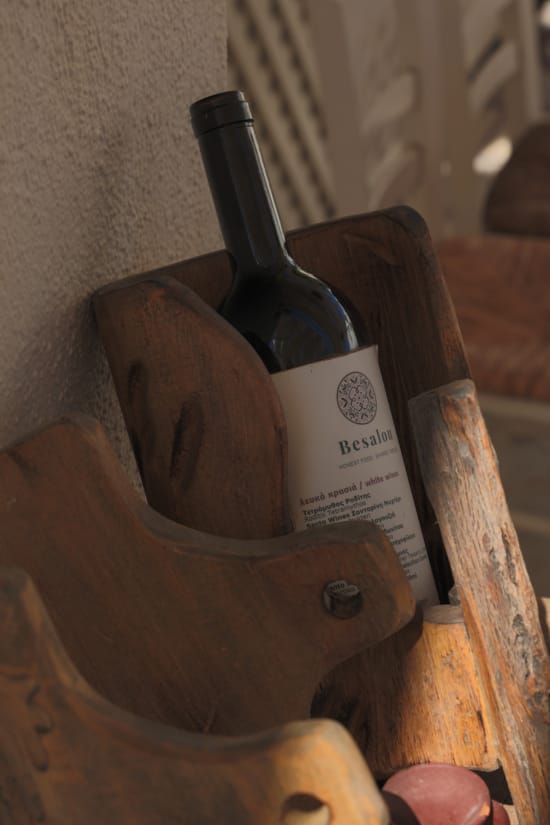 a bottle of wine in a wooden holder