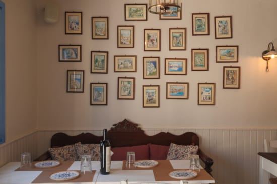 a table with plates and a bottle of wine on it